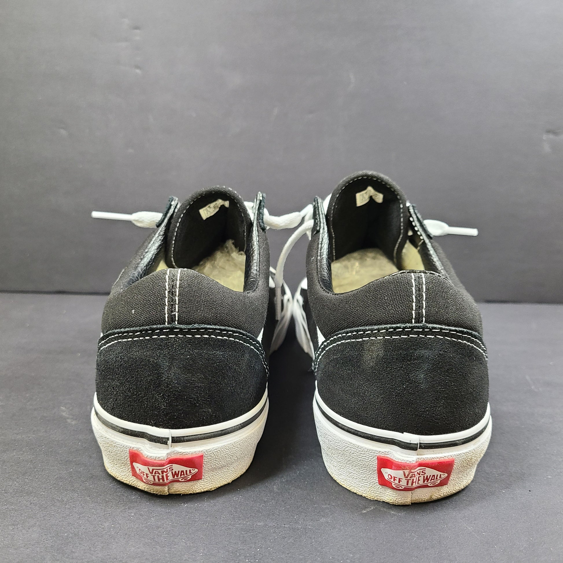 Low-top Vans Old Skool skate shoe in black with a white side stripe and vulcanized sole.