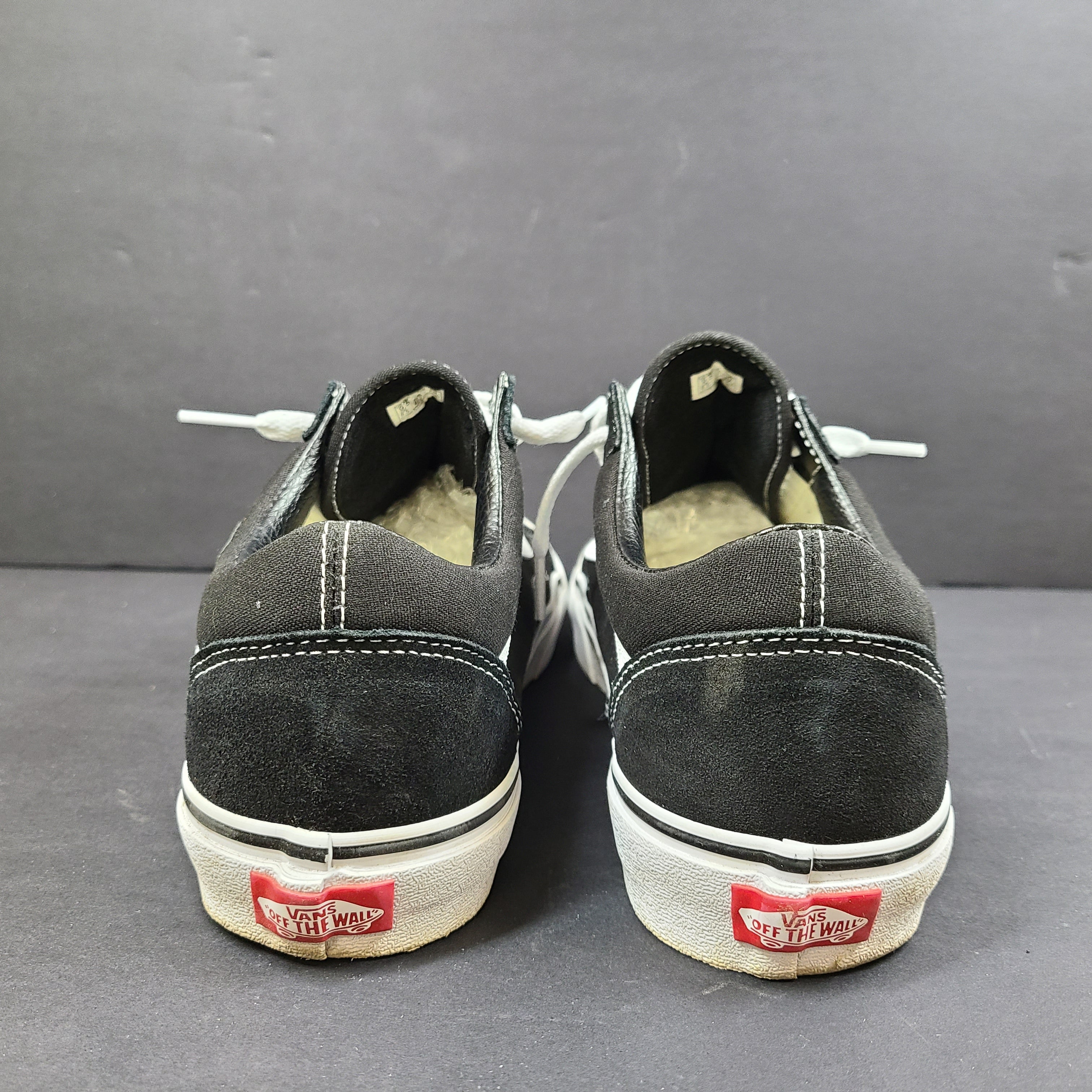 Low-top Vans Old Skool skate shoe in black with a white side stripe and vulcanized sole.