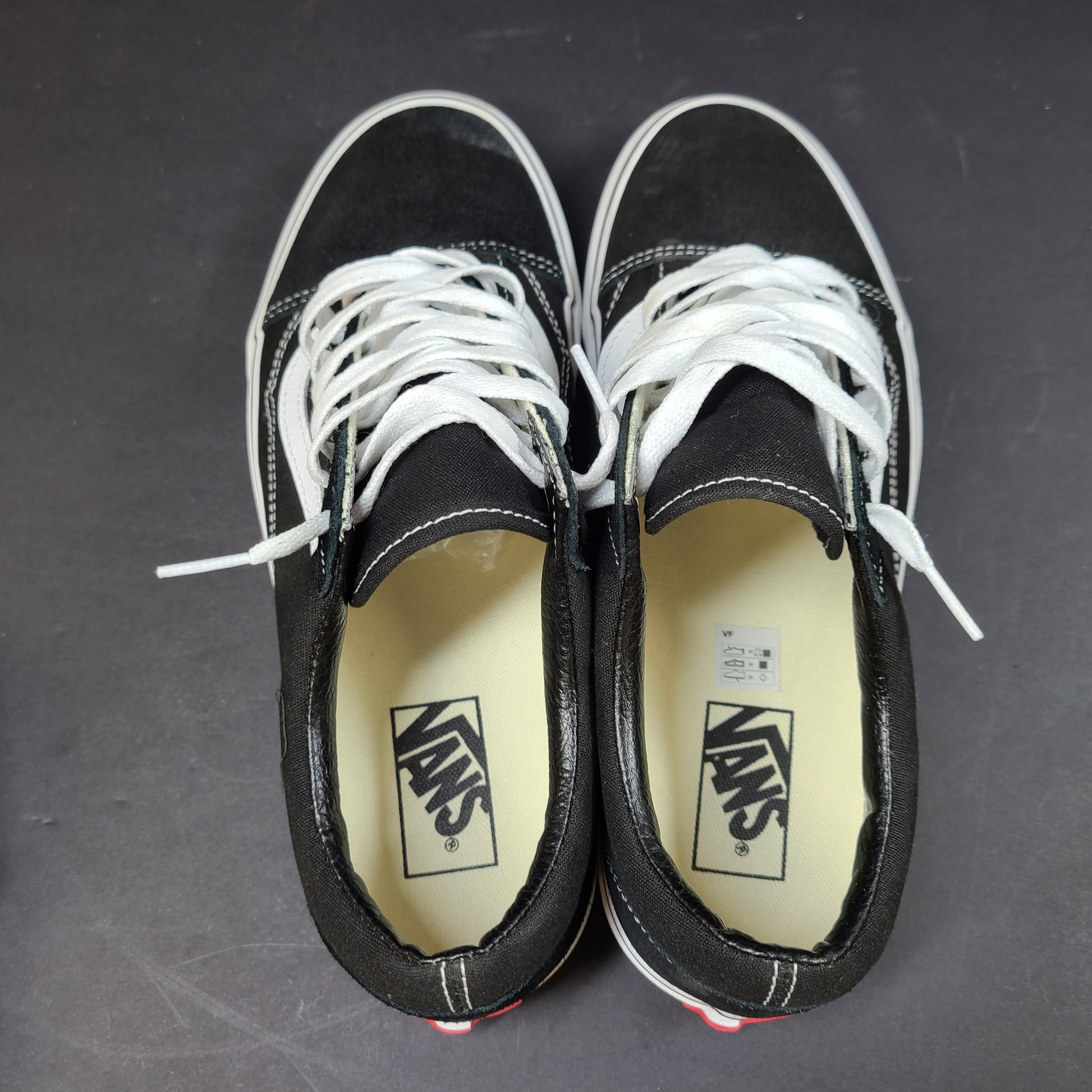 Low-top Vans Old Skool skate shoe in black with a white side stripe and vulcanized sole.