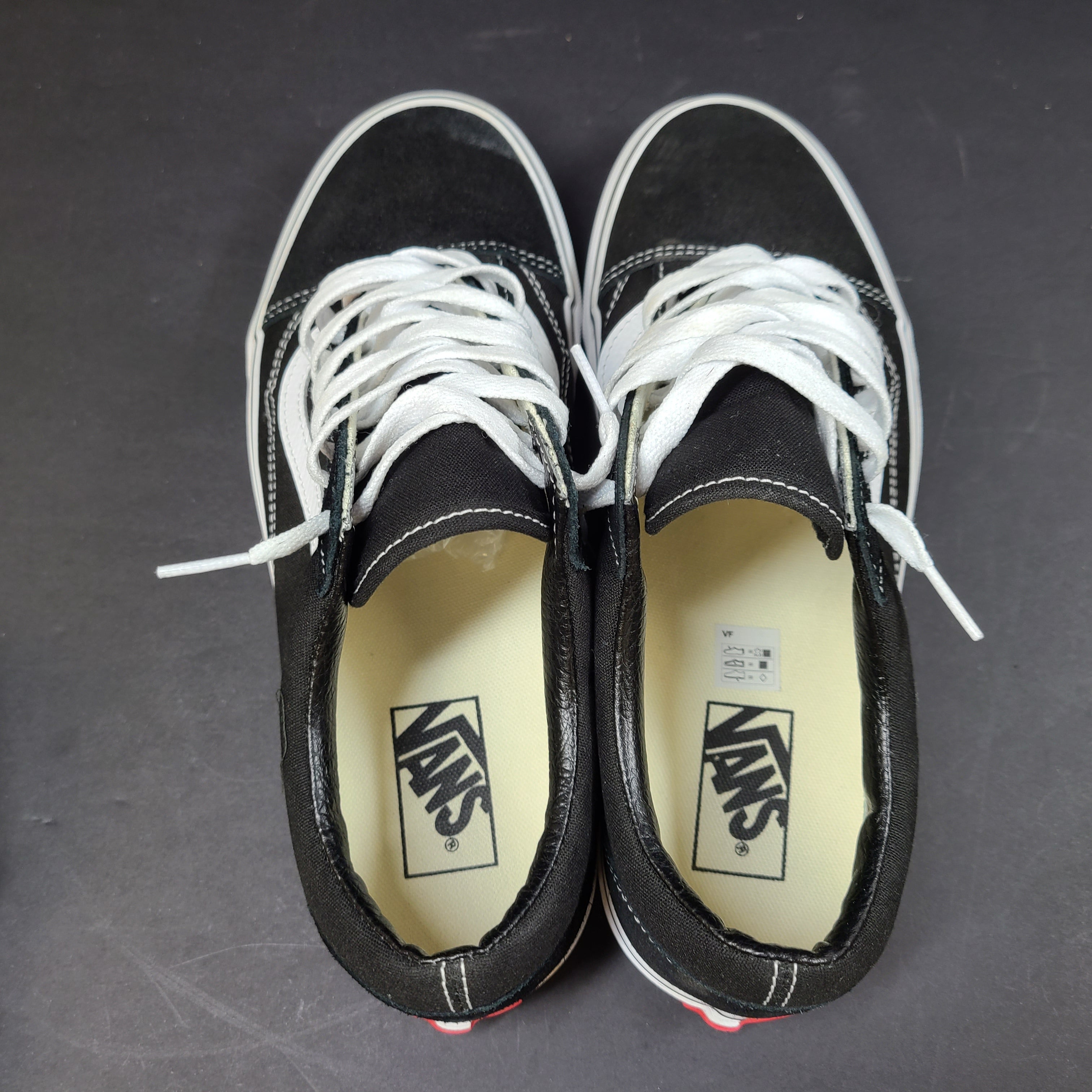 Low-top Vans Old Skool skate shoe in black with a white side stripe and vulcanized sole.