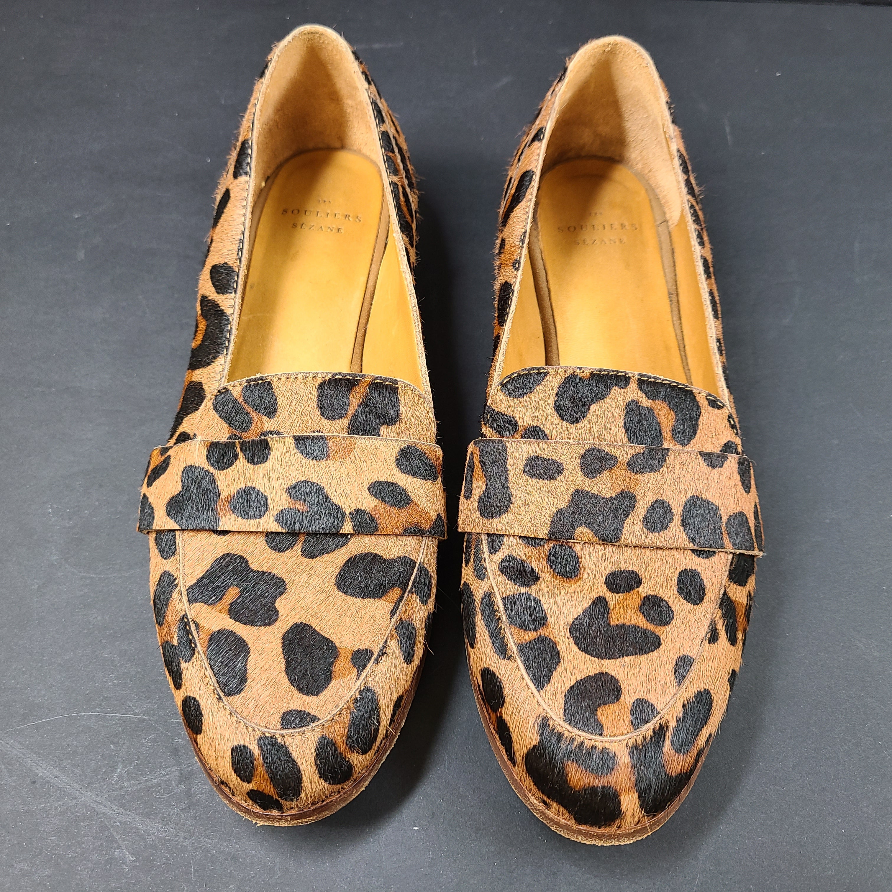 Leopard-print Sézane loafers feature a low profile, branded insole reading "SOULIERS SÉZANE" and a sole stamped "made in Portugal" and 39.