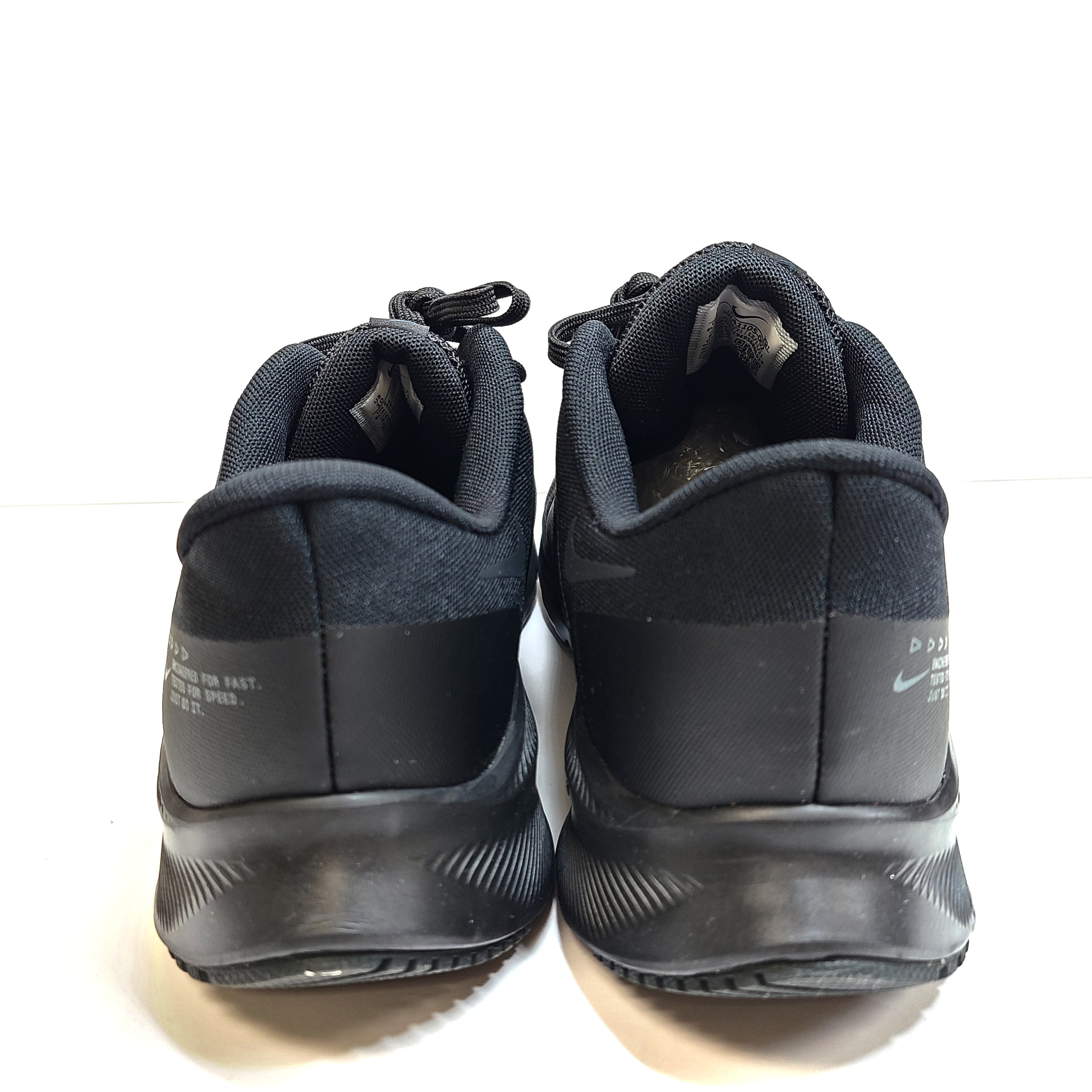 A black Nike Quest 4 running shoe in men's US 10 with breathable mesh upper and cushioned sole.