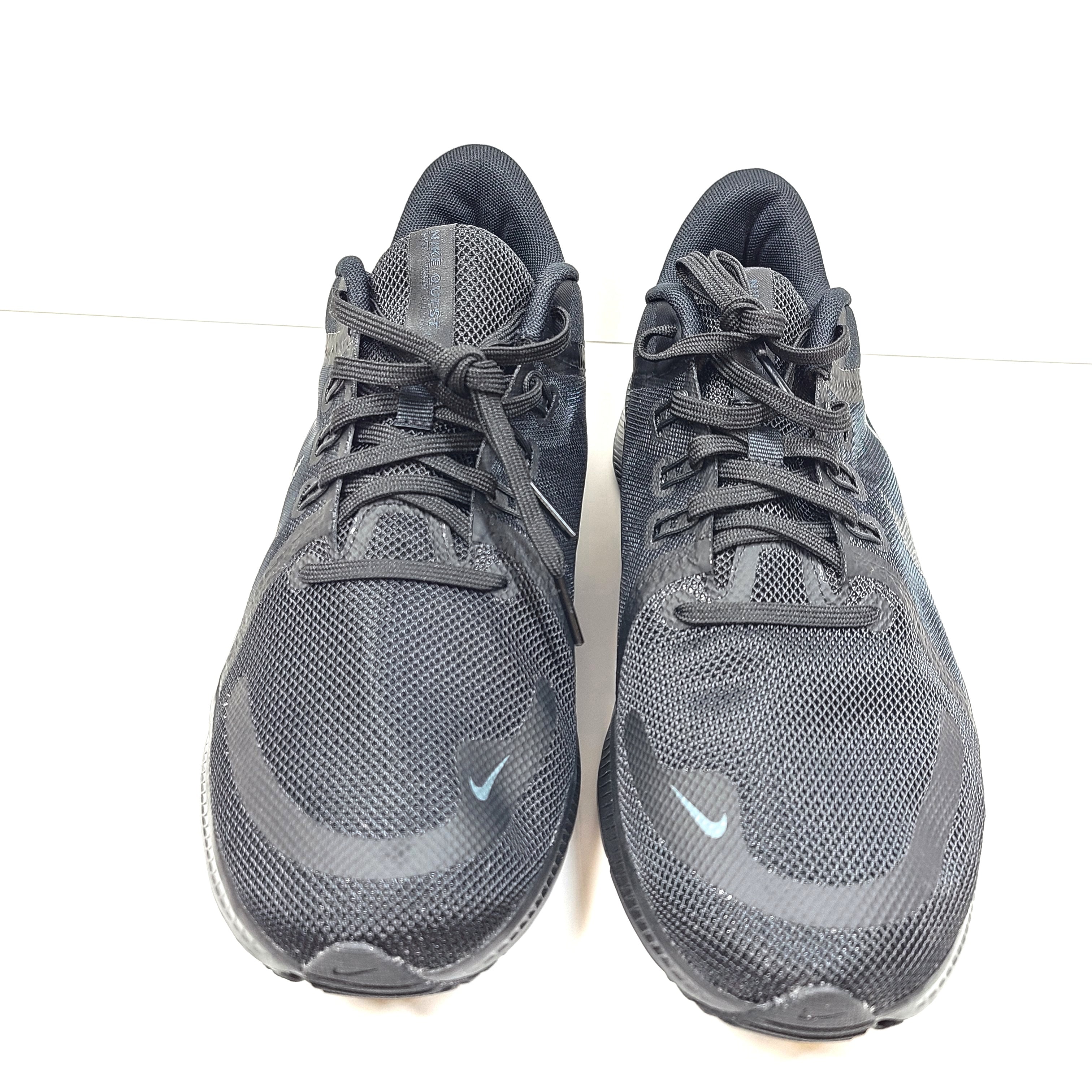 A black Nike Quest 4 running shoe in men's US 10 with breathable mesh upper and cushioned sole.