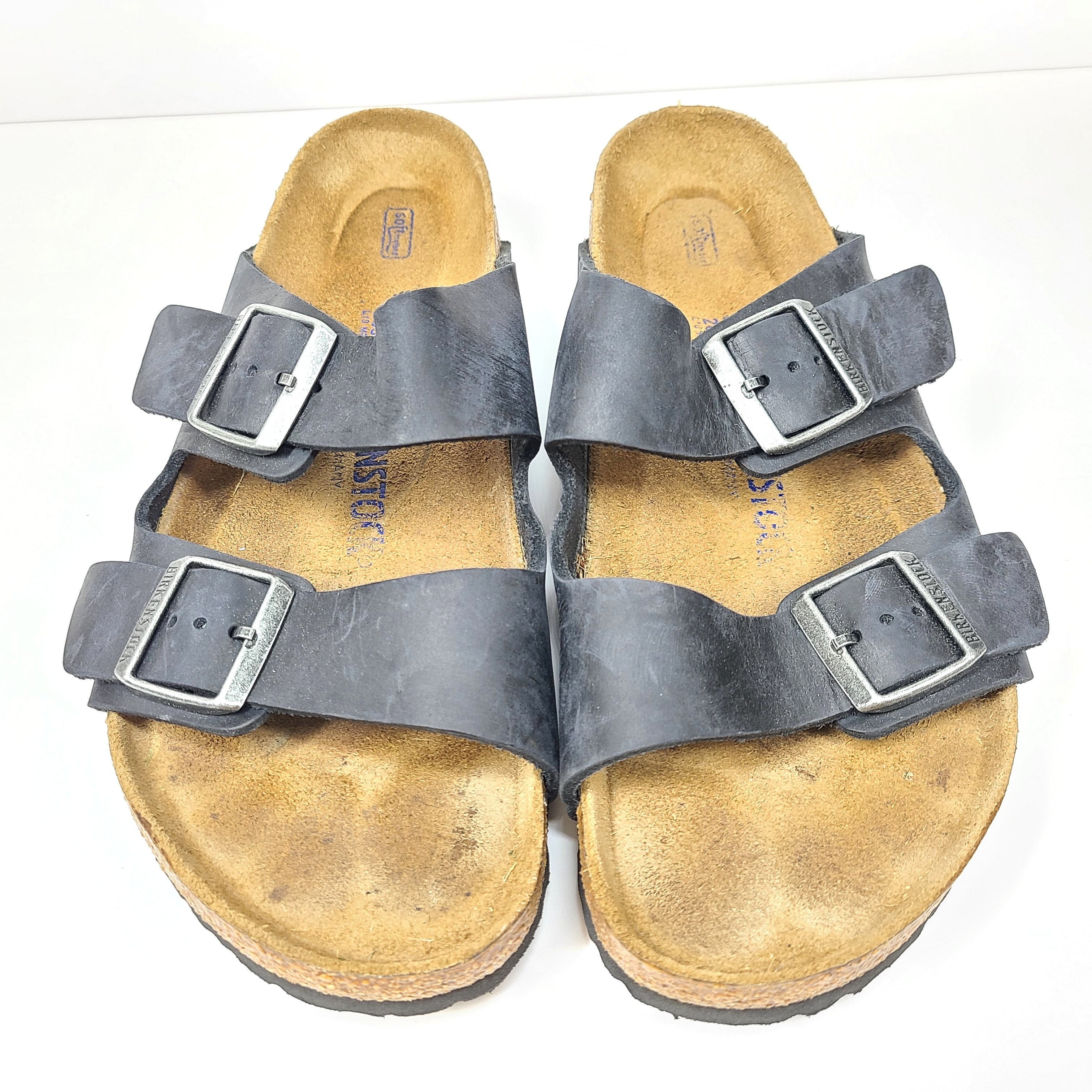 Birkenstock Arizona two-strap black sandals, size 41, with worn footbed and intact straps and soles.