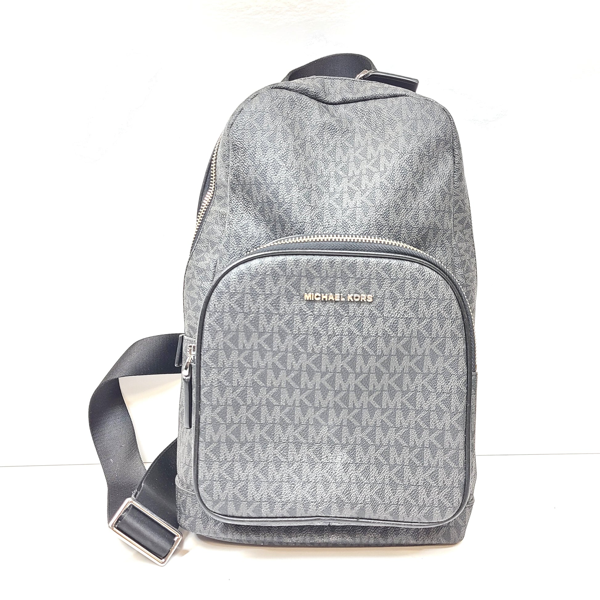 A grey Michael Kors backpack model 1239NHNP with leather finish and a structured silhouette.