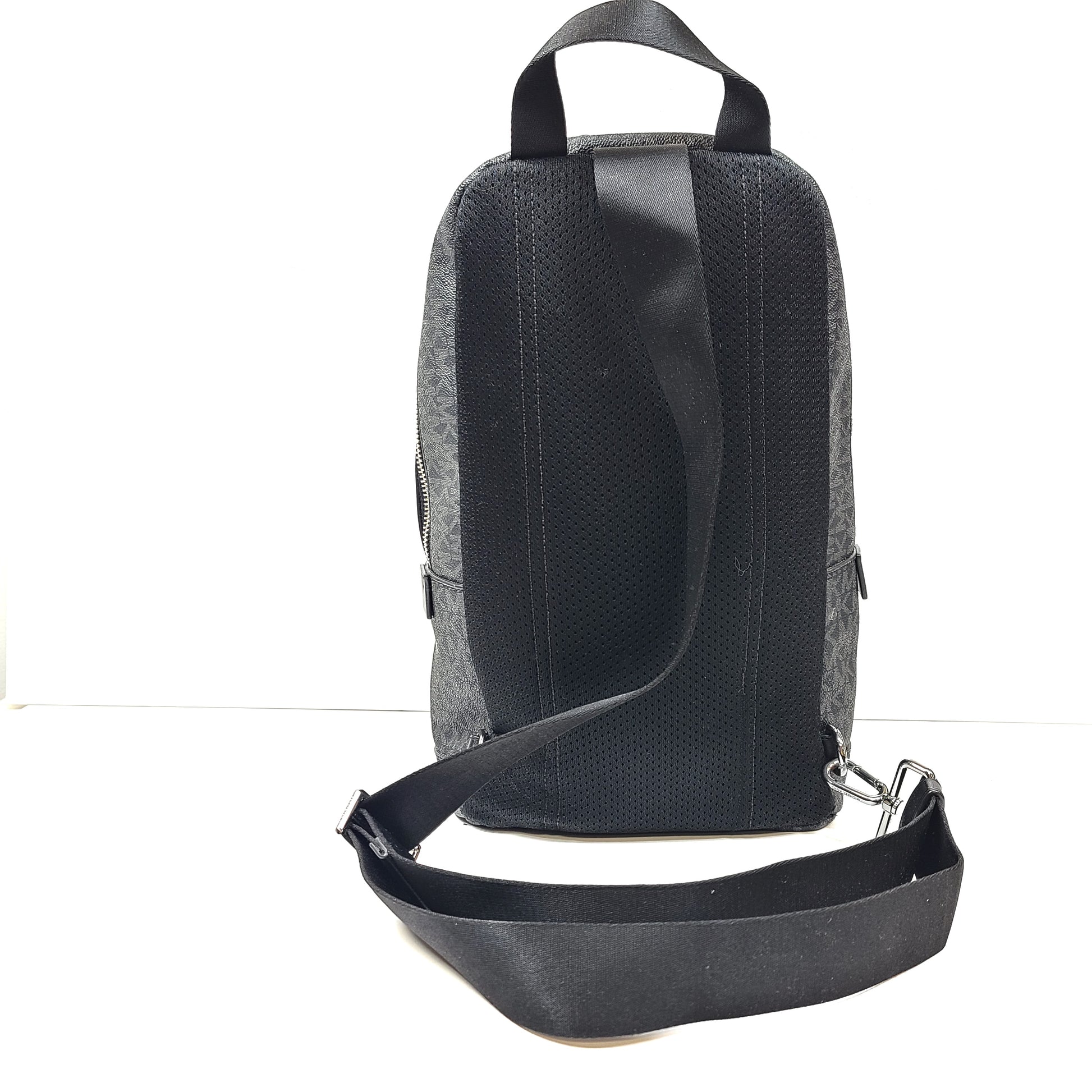 A grey Michael Kors backpack model 1239NHNP with leather finish and a structured silhouette.