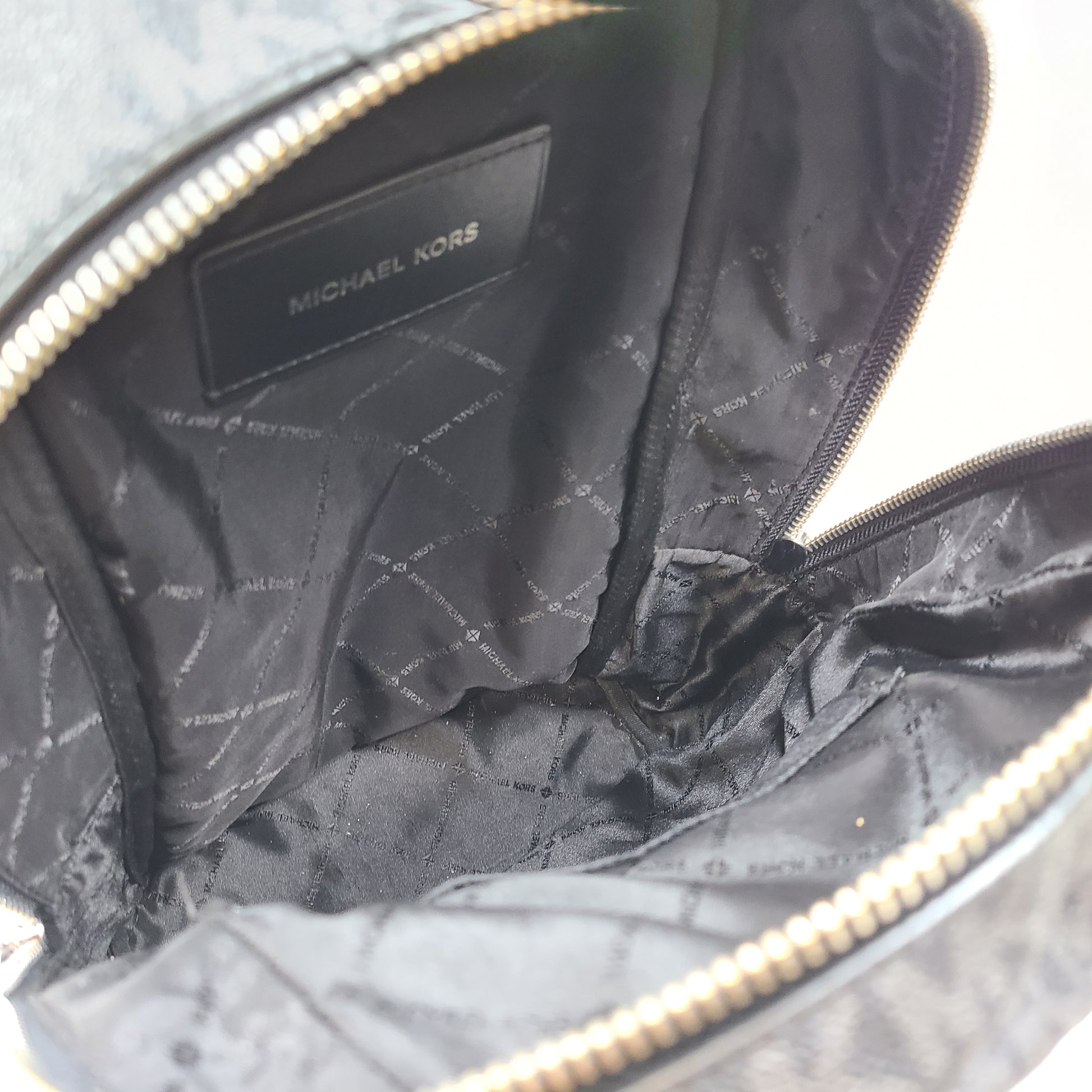 A grey Michael Kors backpack model 1239NHNP with leather finish and a structured silhouette.