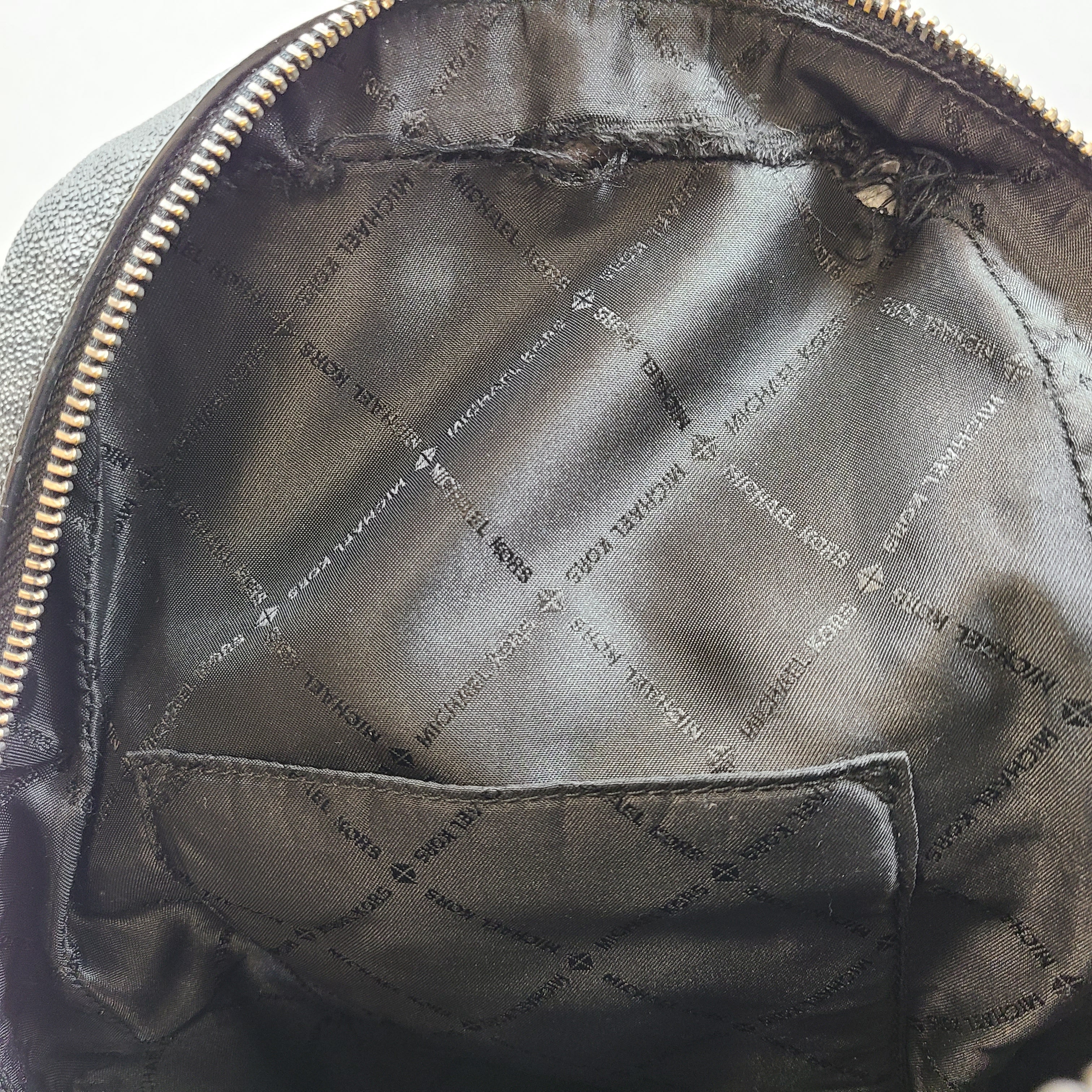 A grey Michael Kors backpack model 1239NHNP with leather finish and a structured silhouette.