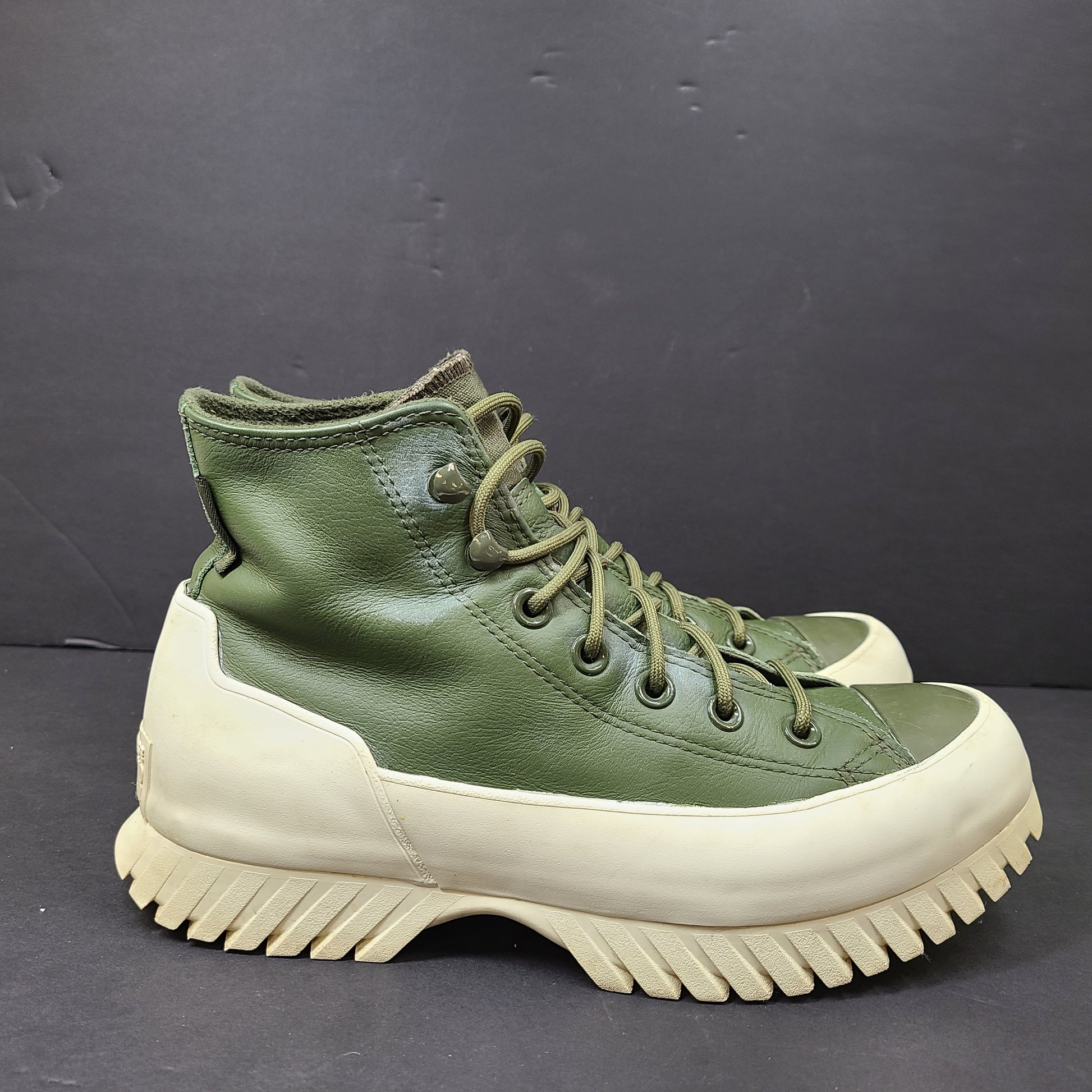 Olive and white Converse All Star Counter Climate waterproof boots with lugged rubber outsoles and leather upper.