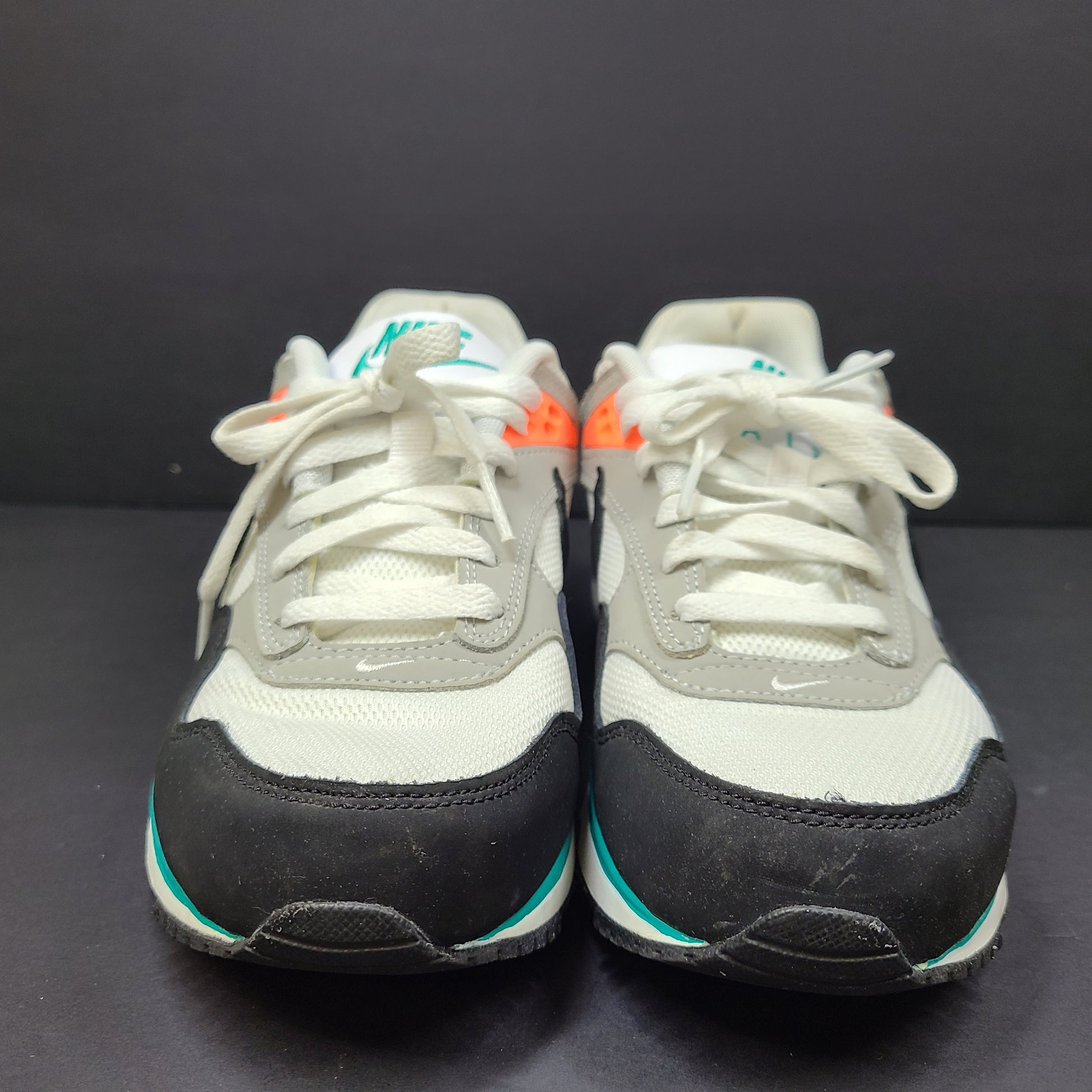 Nike Air Max Correlate in white, black and orange with Air Max cushioning and a low-top silhouette.