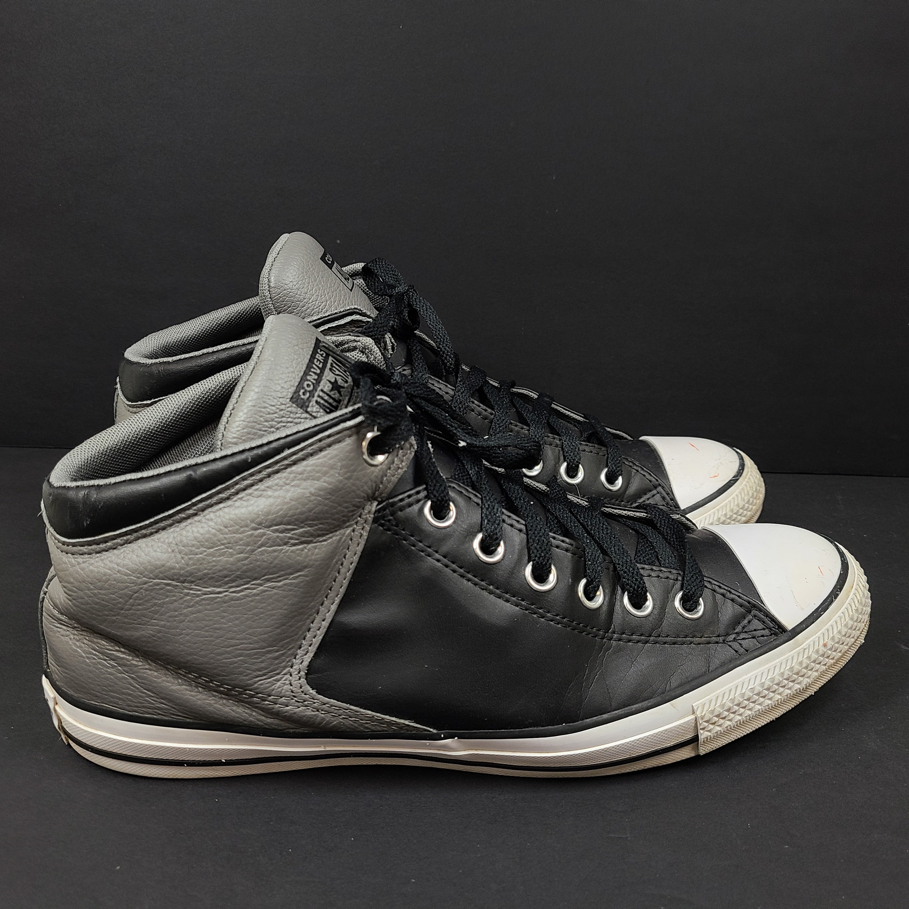 Black and grey Converse All Star high-top sneakers in men's size 12 with rubber outsoles and textile lining.