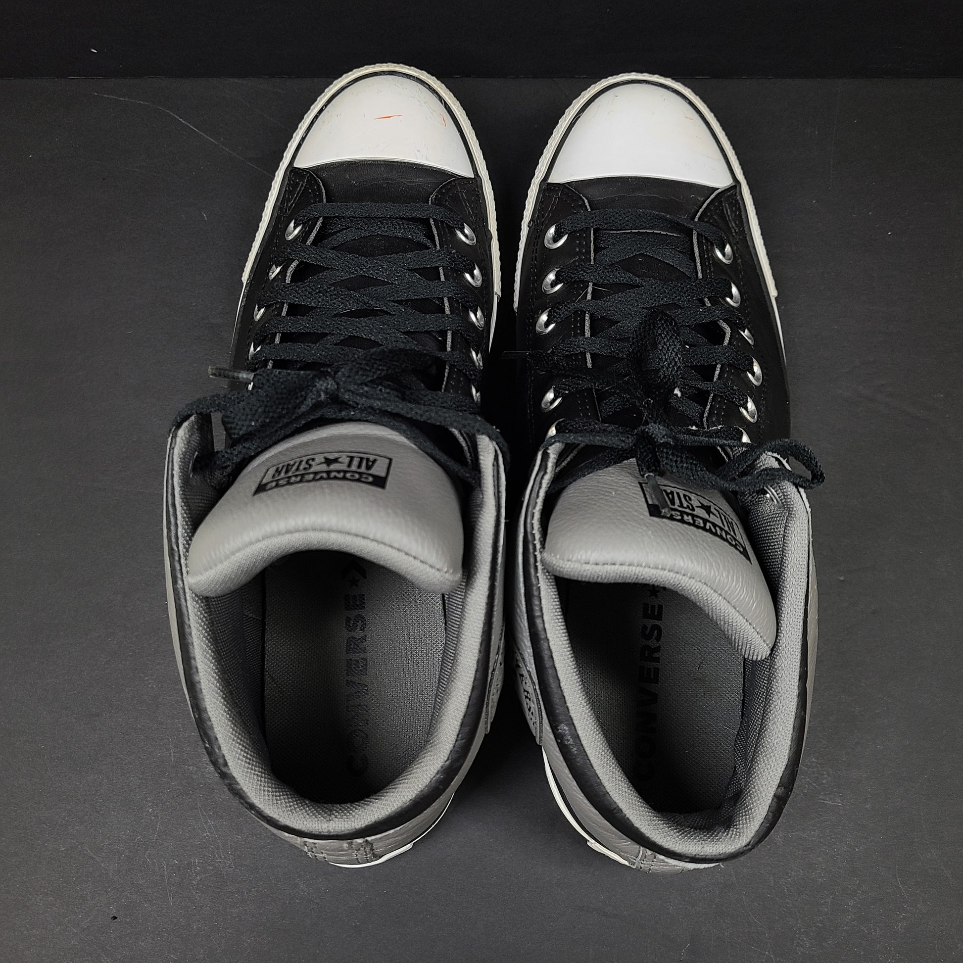 Black and grey Converse All Star high-top sneakers in men's size 12 with rubber outsoles and textile lining.