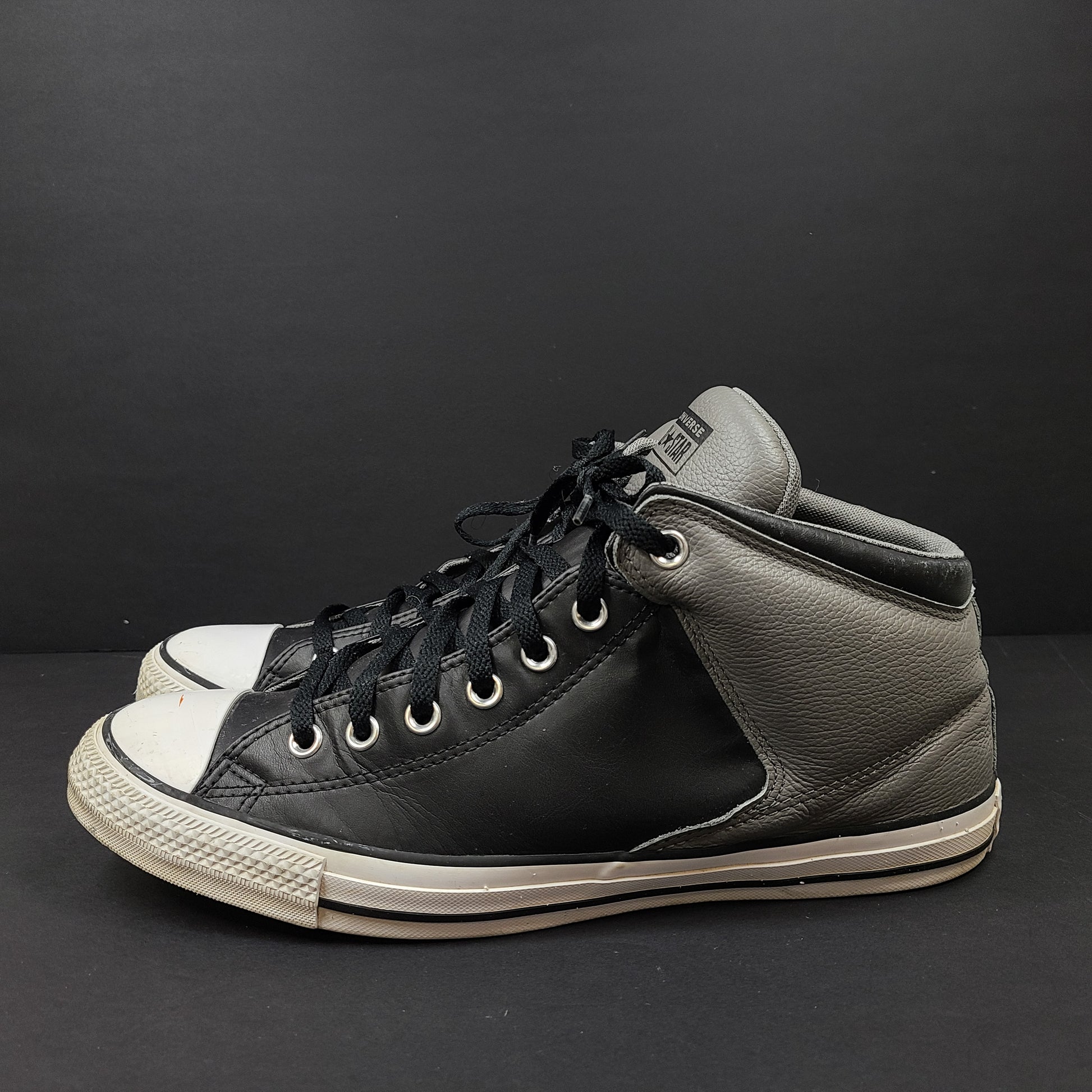 Black and grey Converse All Star high-top sneakers in men's size 12 with rubber outsoles and textile lining.