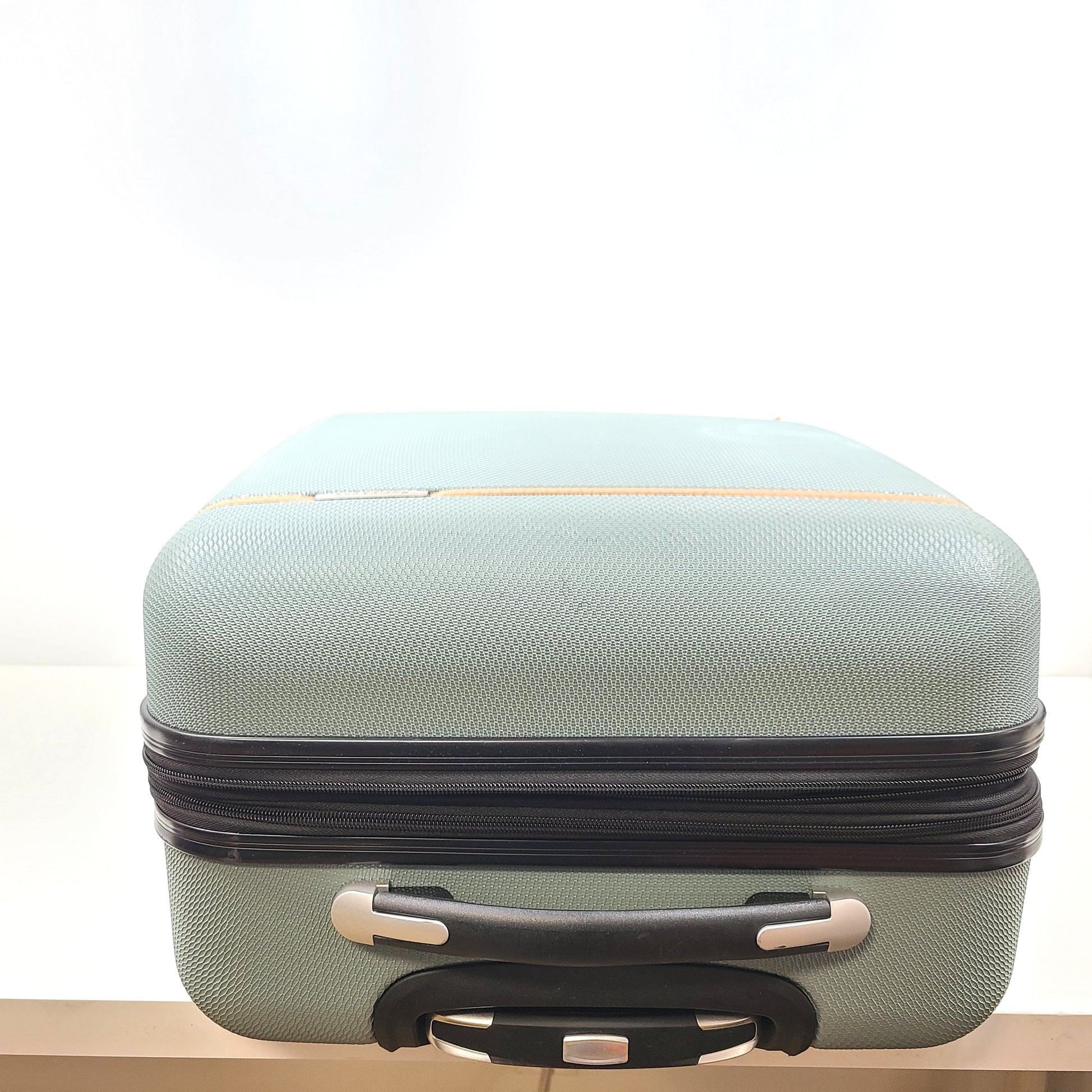 A light blue Samsonite medium suitcase with yellow accents and a front Samsonite logo.