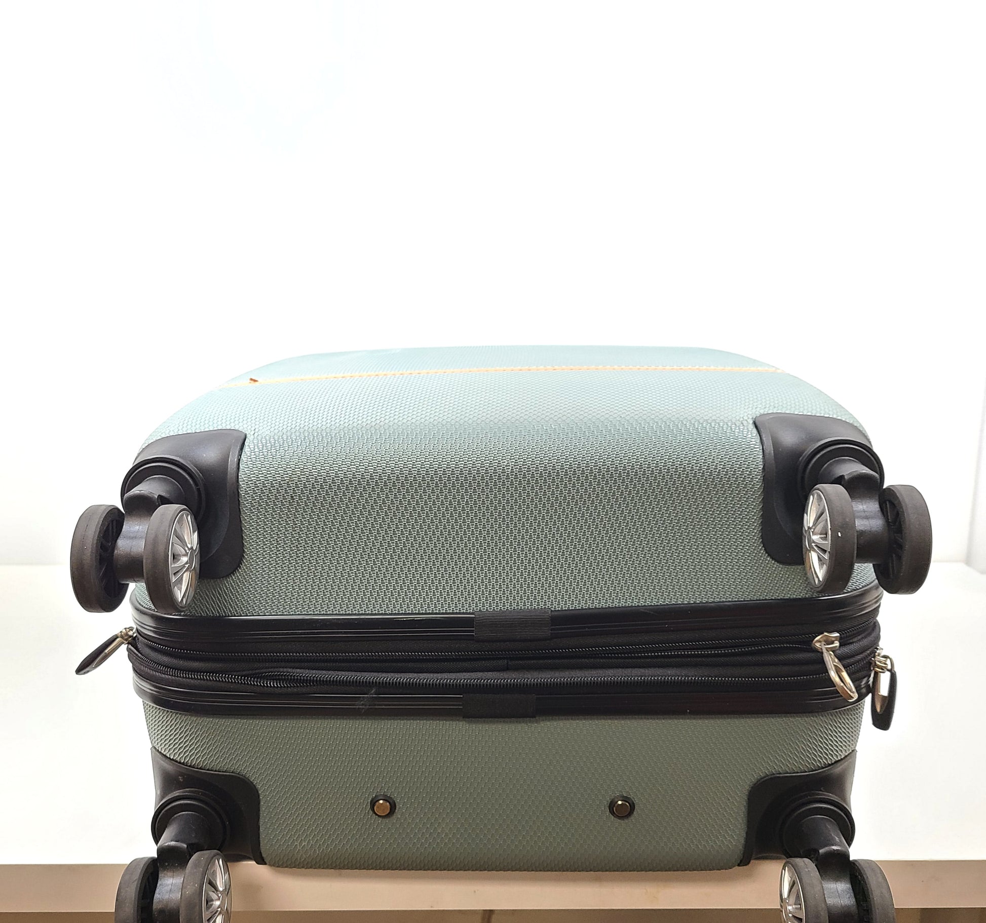 A light blue Samsonite medium suitcase with yellow accents and a front Samsonite logo.