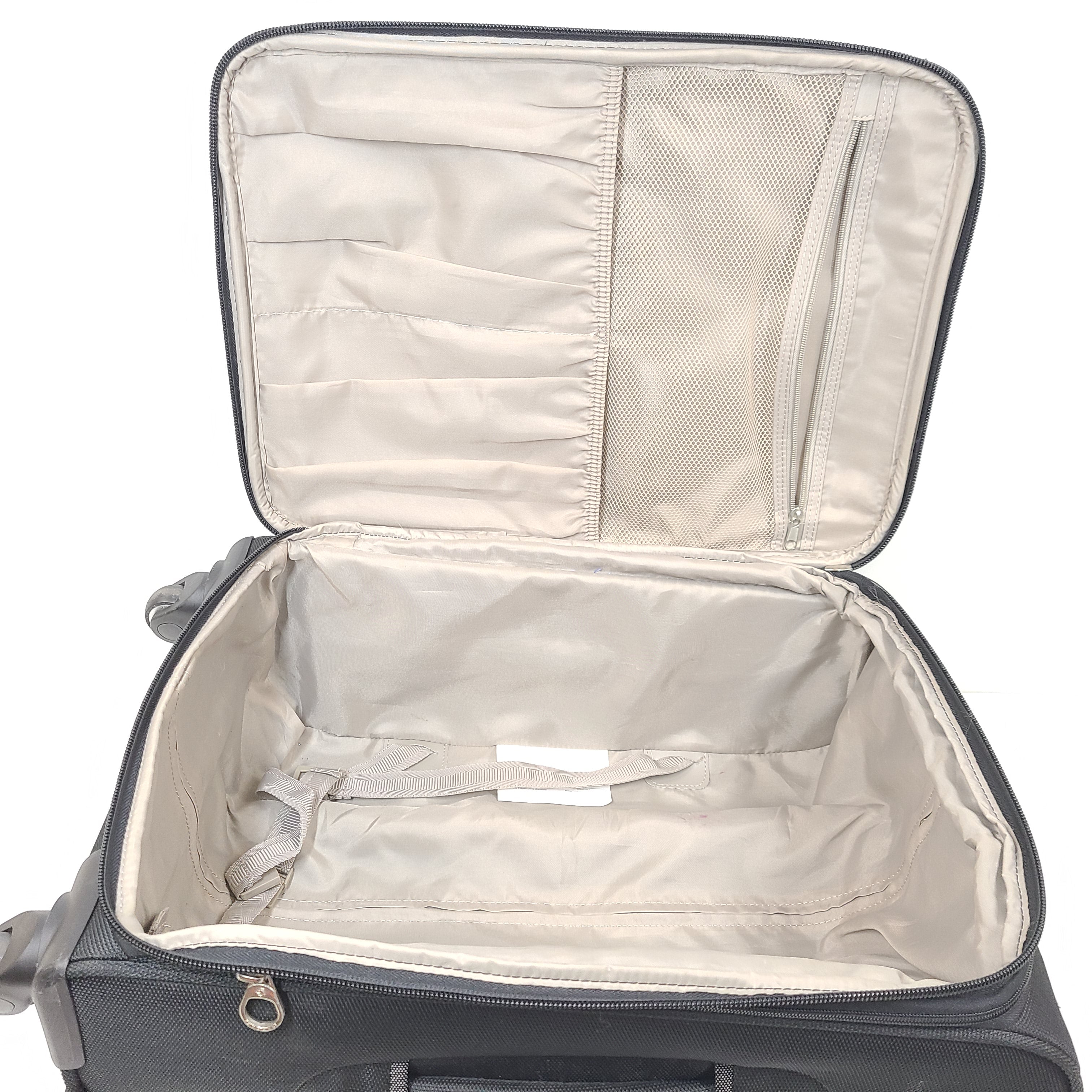 Black Samsonite suitcase QC-002454 with minor scuff marks and labeled material composition.