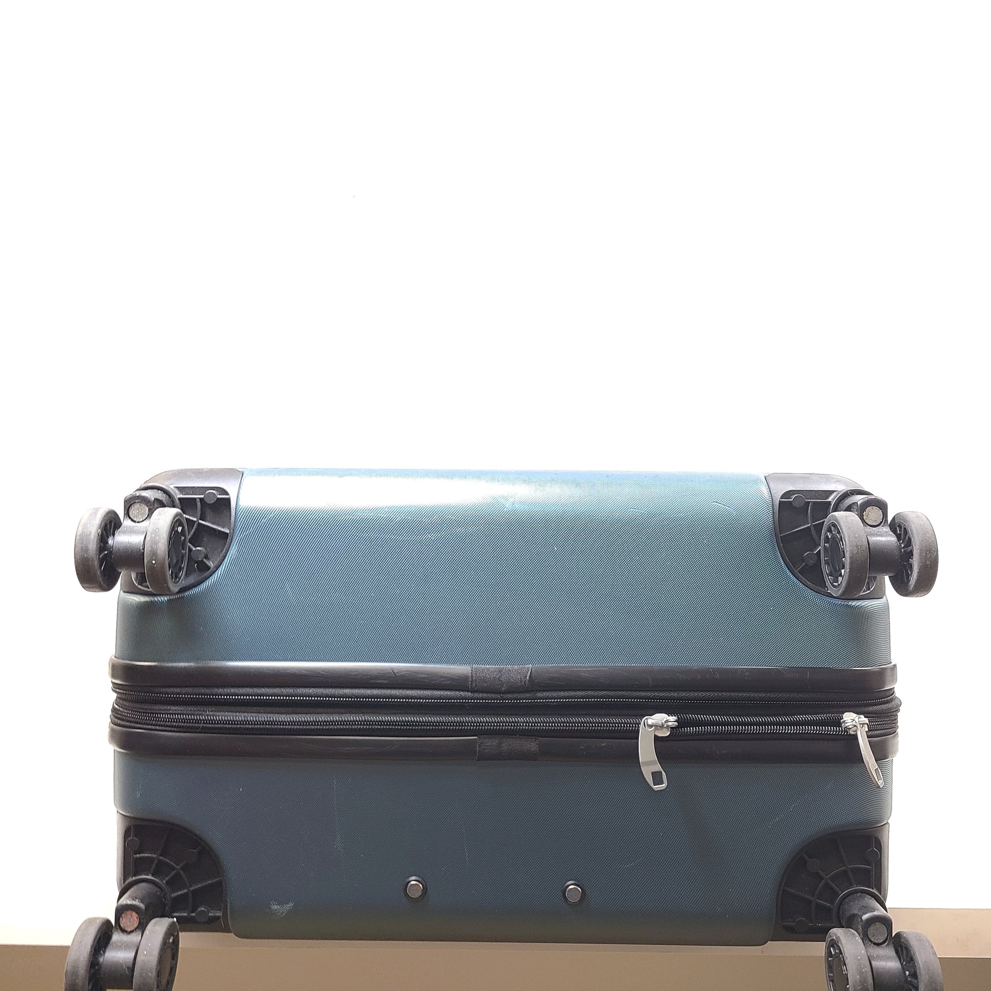 A blue Samsonite suitcase with scuffs and scratches on the exterior and a clean, well-kept interior.