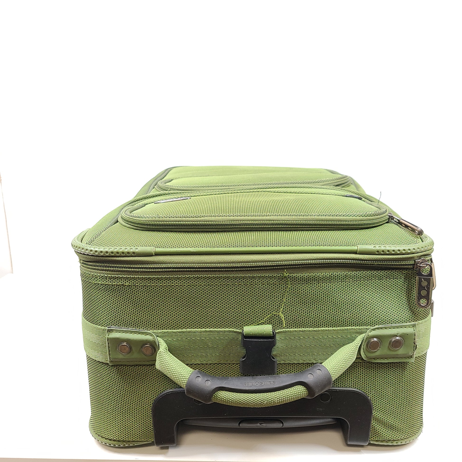 Green Samsonite suitcase model 4500025904 with scuff marks on wheels and handles.