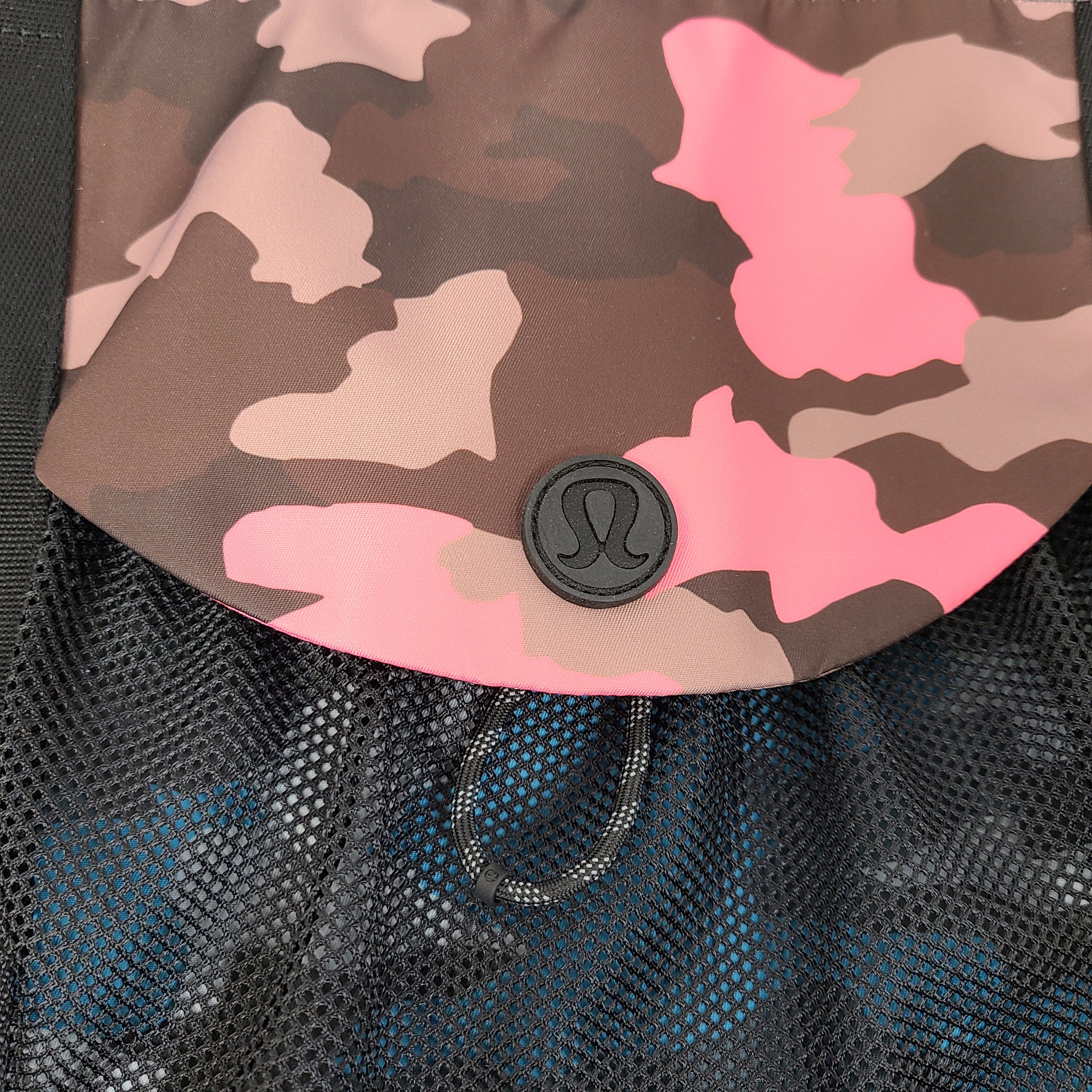 Multicolor Lululemon camouflage tote with pink, brown, green and blue panels and an internal label reading "items of importance".