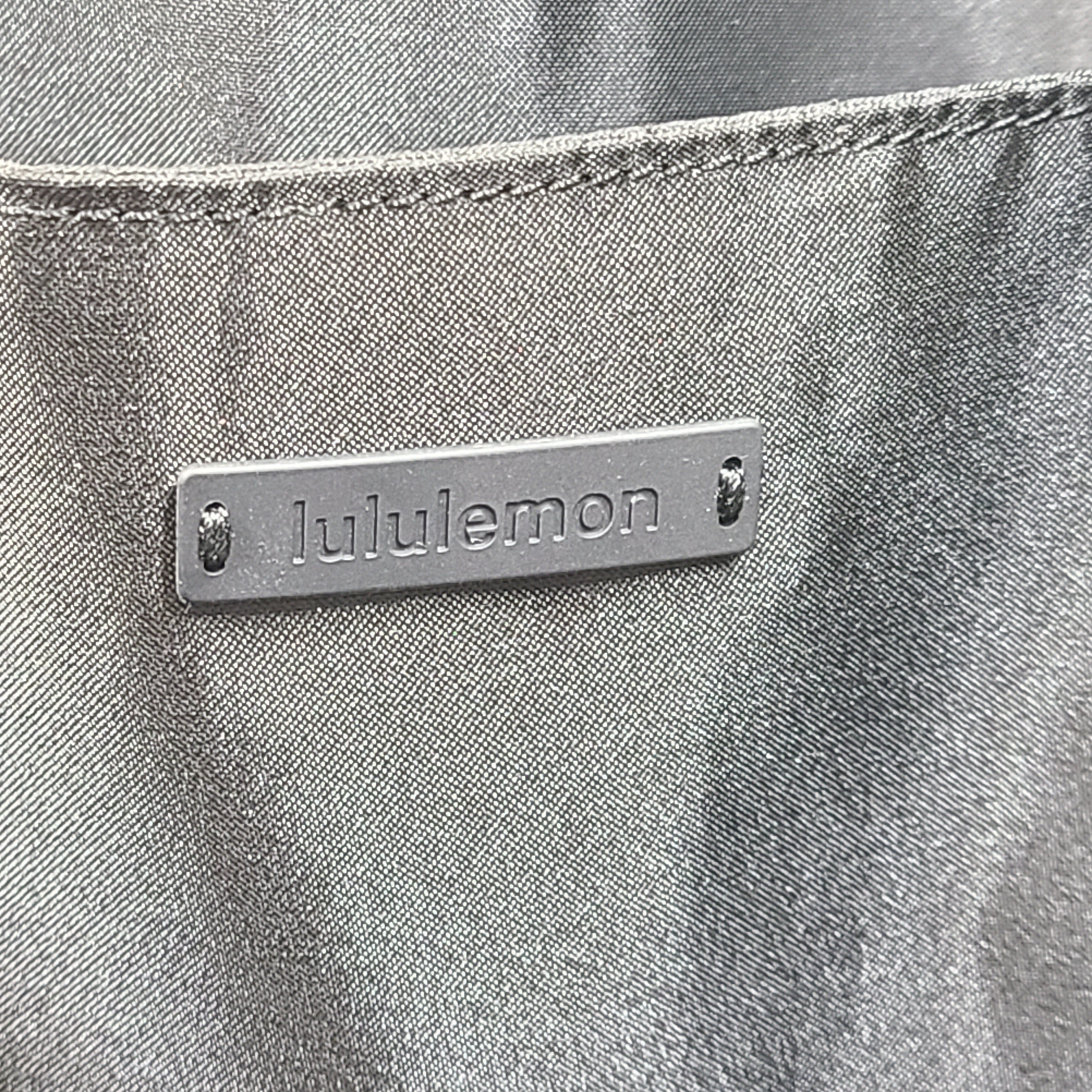 Multicolor Lululemon camouflage tote with pink, brown, green and blue panels and an internal label reading "items of importance".