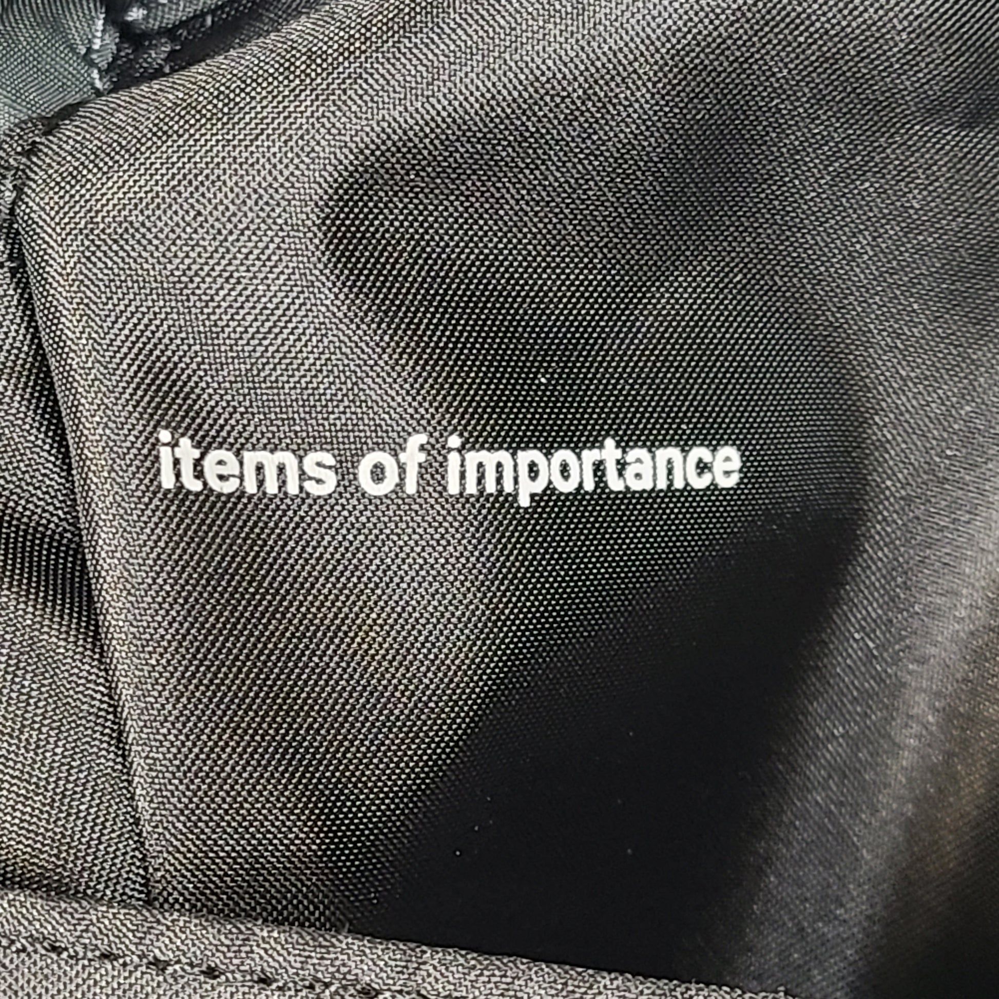 Multicolor Lululemon camouflage tote with pink, brown, green and blue panels and an internal label reading "items of importance".