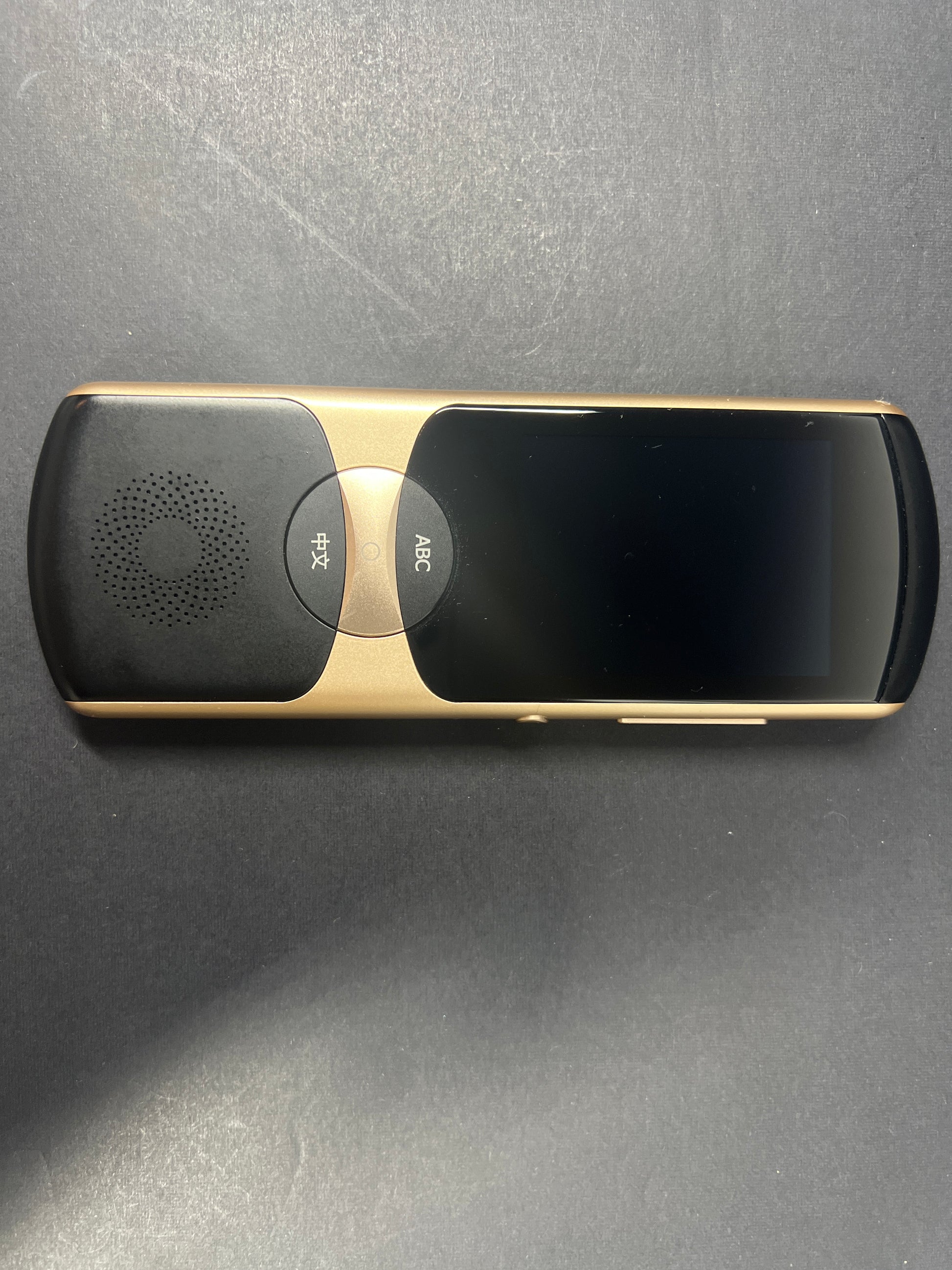 Black and gold iFLYTEK AIT02 voice translator showing front and back with buttons and display screen visible