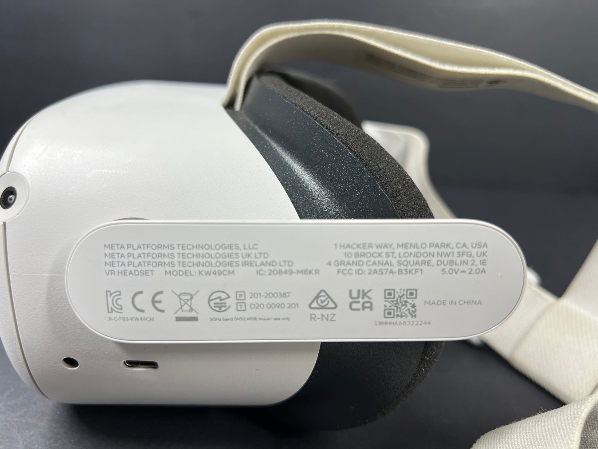 Close-up of Meta Quest 2 VR headset model label with branding, certification logos, and model number KW49CM visible.