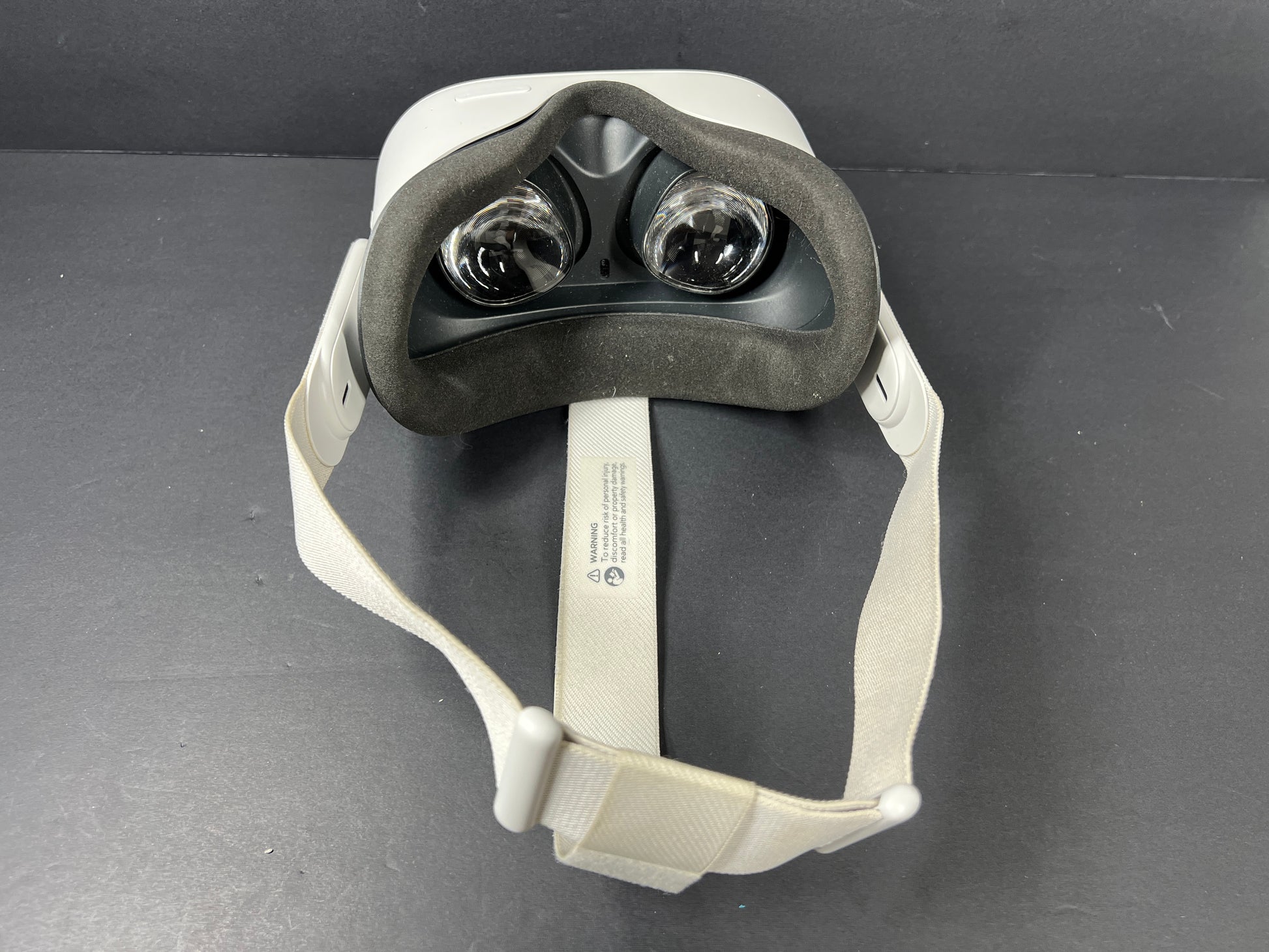 Close-up of Meta Quest 2 VR headset model label with branding, certification logos, and model number KW49CM visible.
