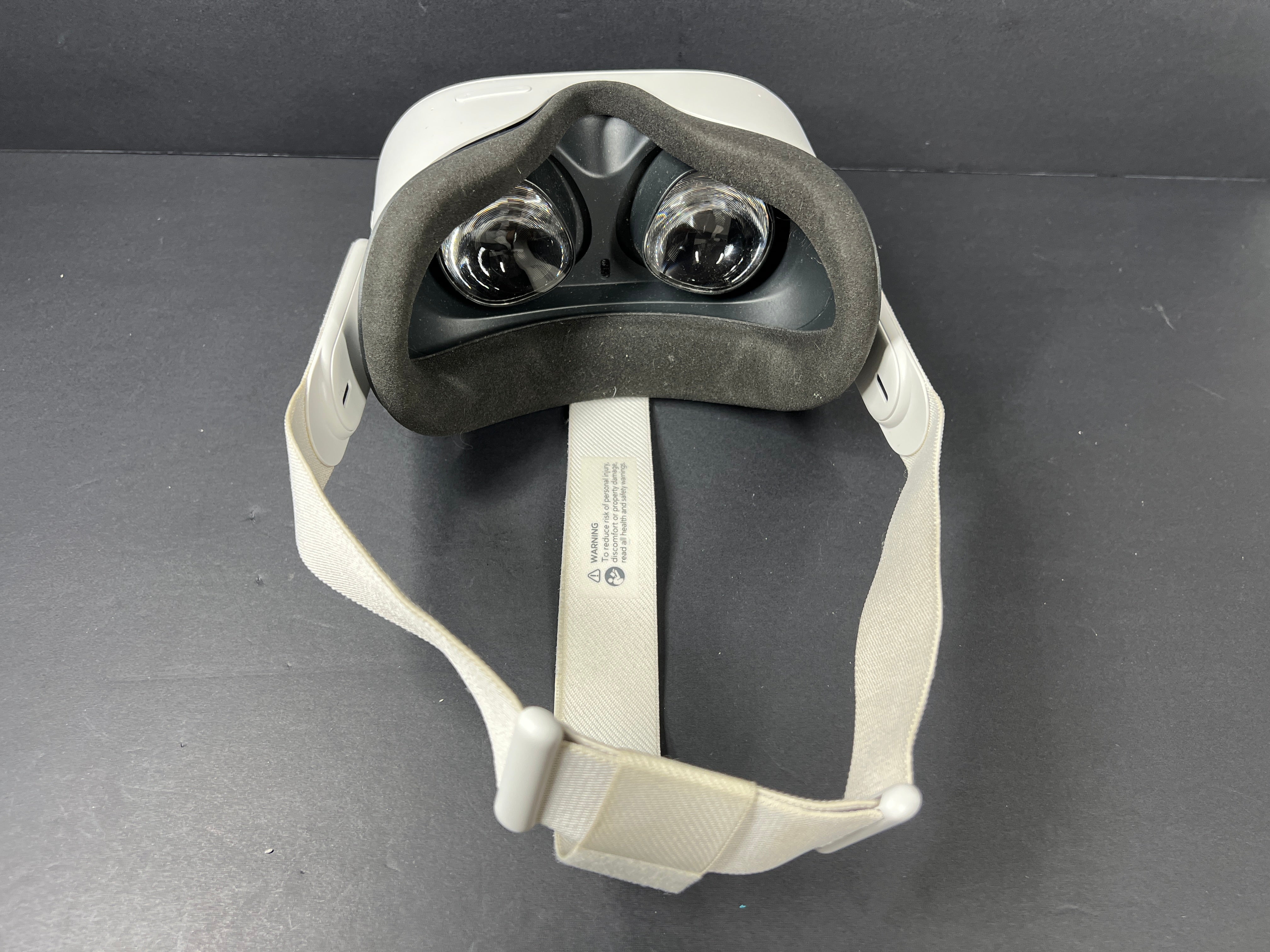 Close-up of Meta Quest 2 VR headset model label with branding, certification logos, and model number KW49CM visible.