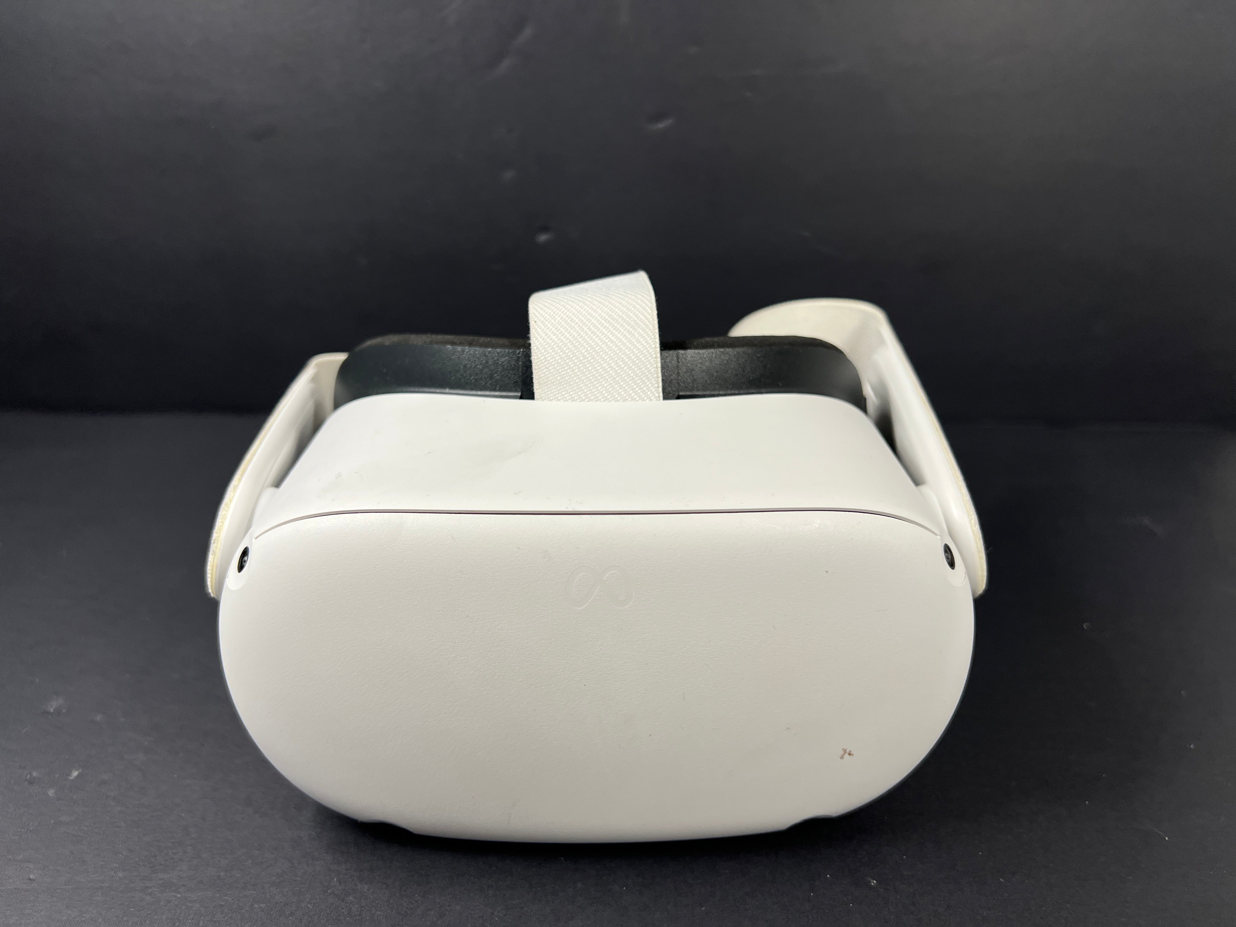 Image of the Meta Quest 2 VR headset from a side angle, showing design details and wearing strap.