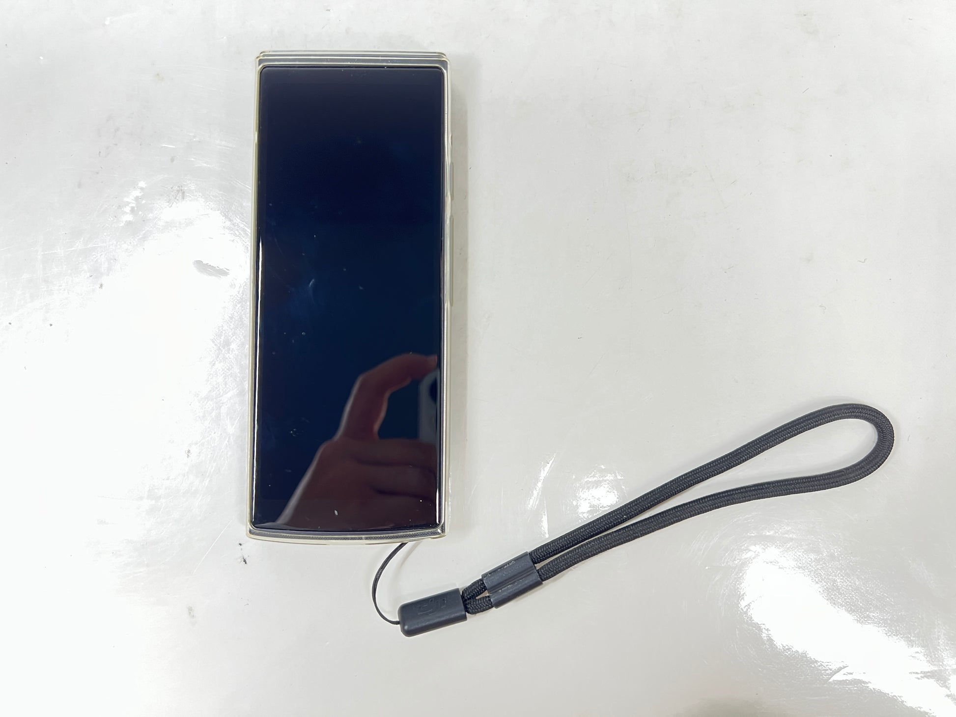 iFlytek Translator 4.0 AI device in navy with wrist strap, rear camera, and side buttons shown