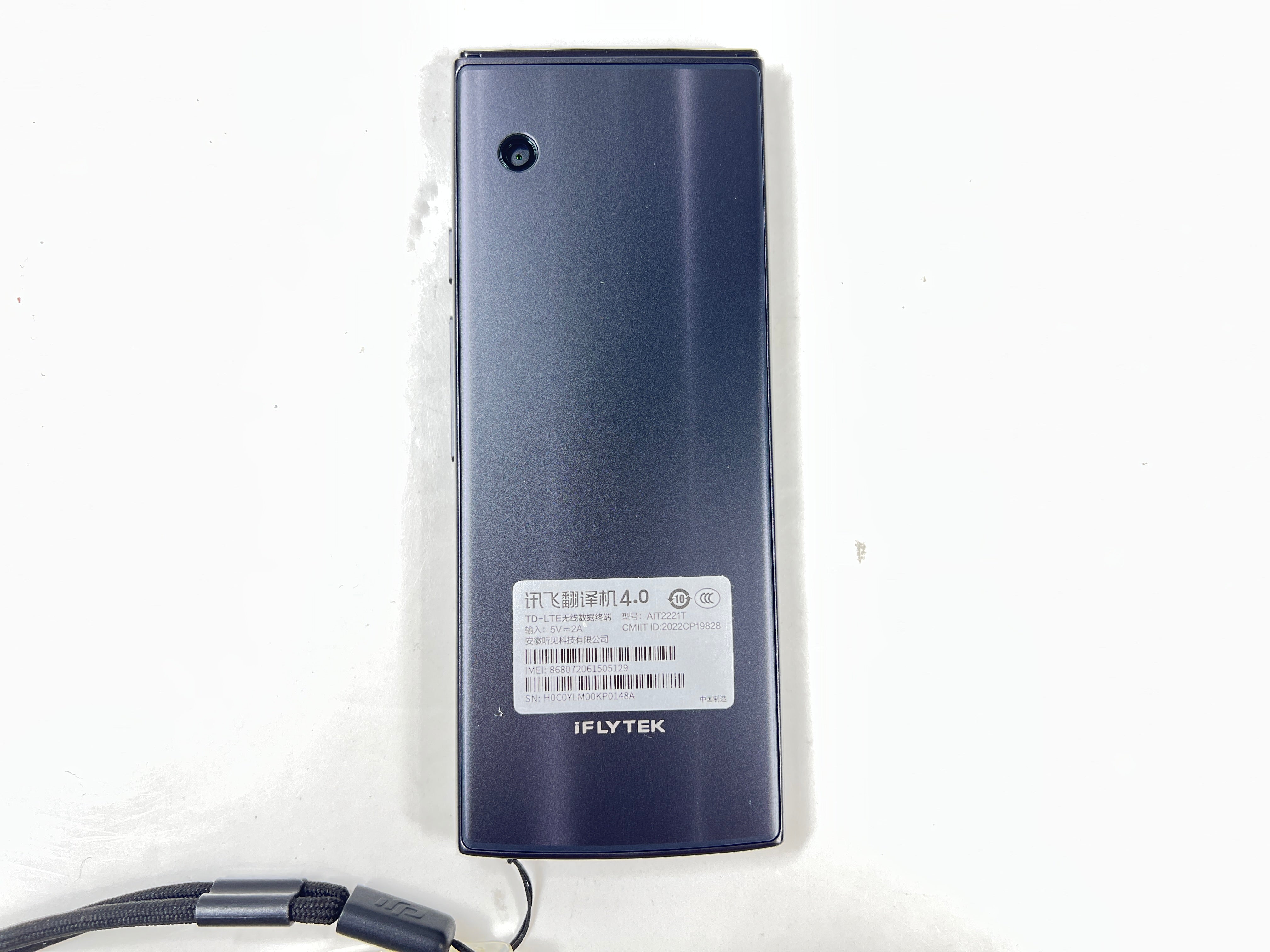 iFlytek Translator 4.0 AI device in navy with wrist strap, rear camera, and side buttons shown