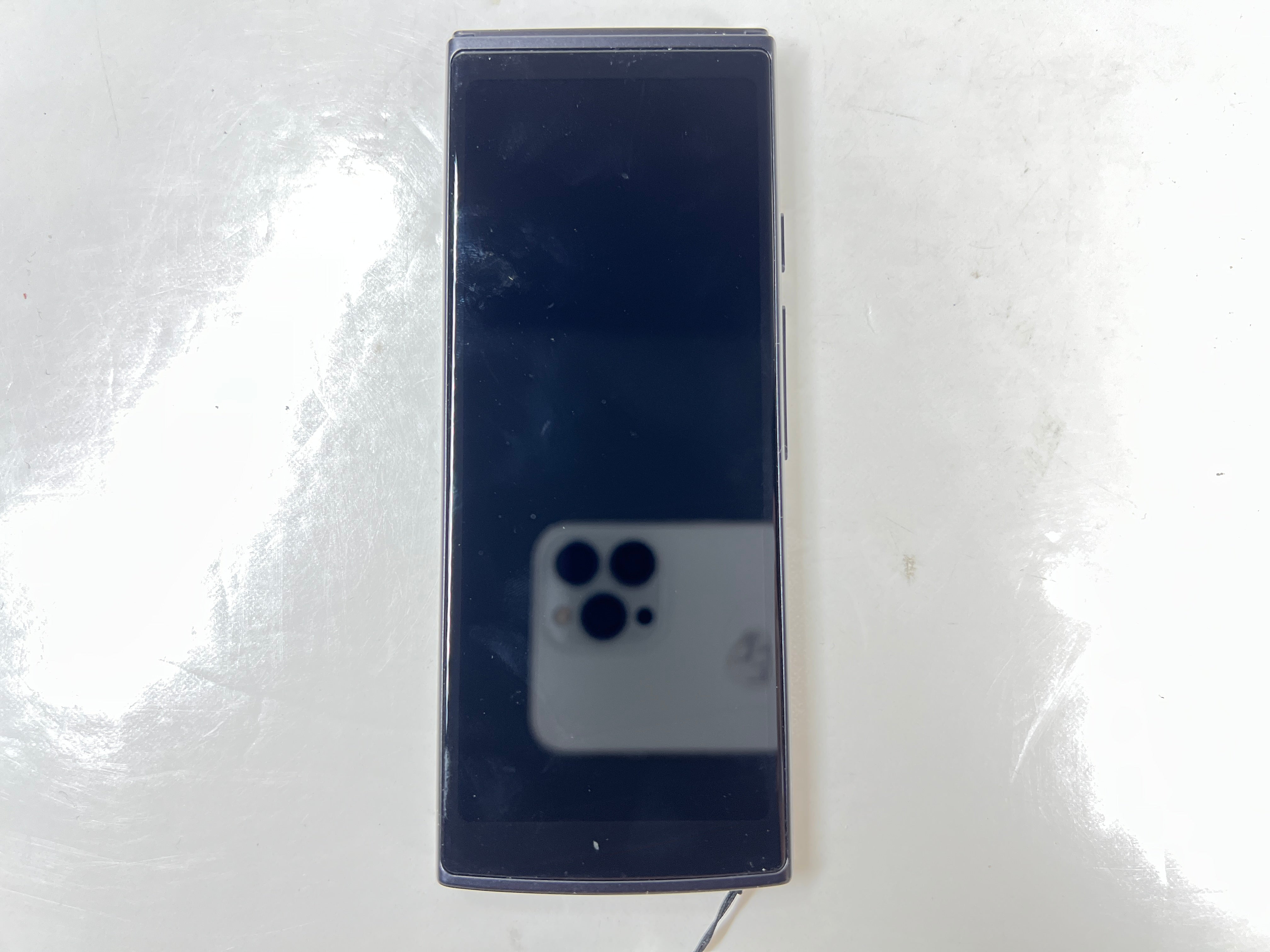 iFlytek Translator 4.0 AI device in navy with wrist strap, rear camera, and side buttons shown