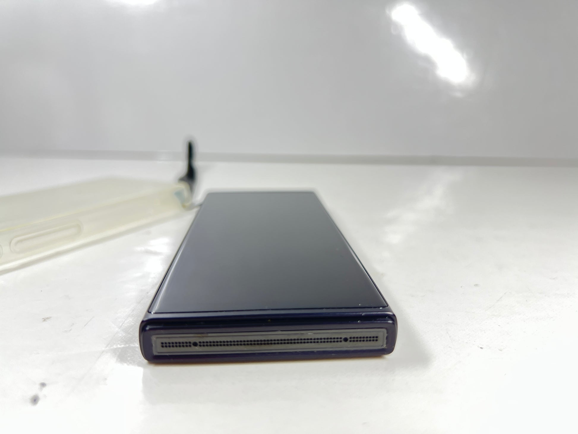 iFlytek Translator 4.0 AI device in navy with wrist strap, rear camera, and side buttons shown