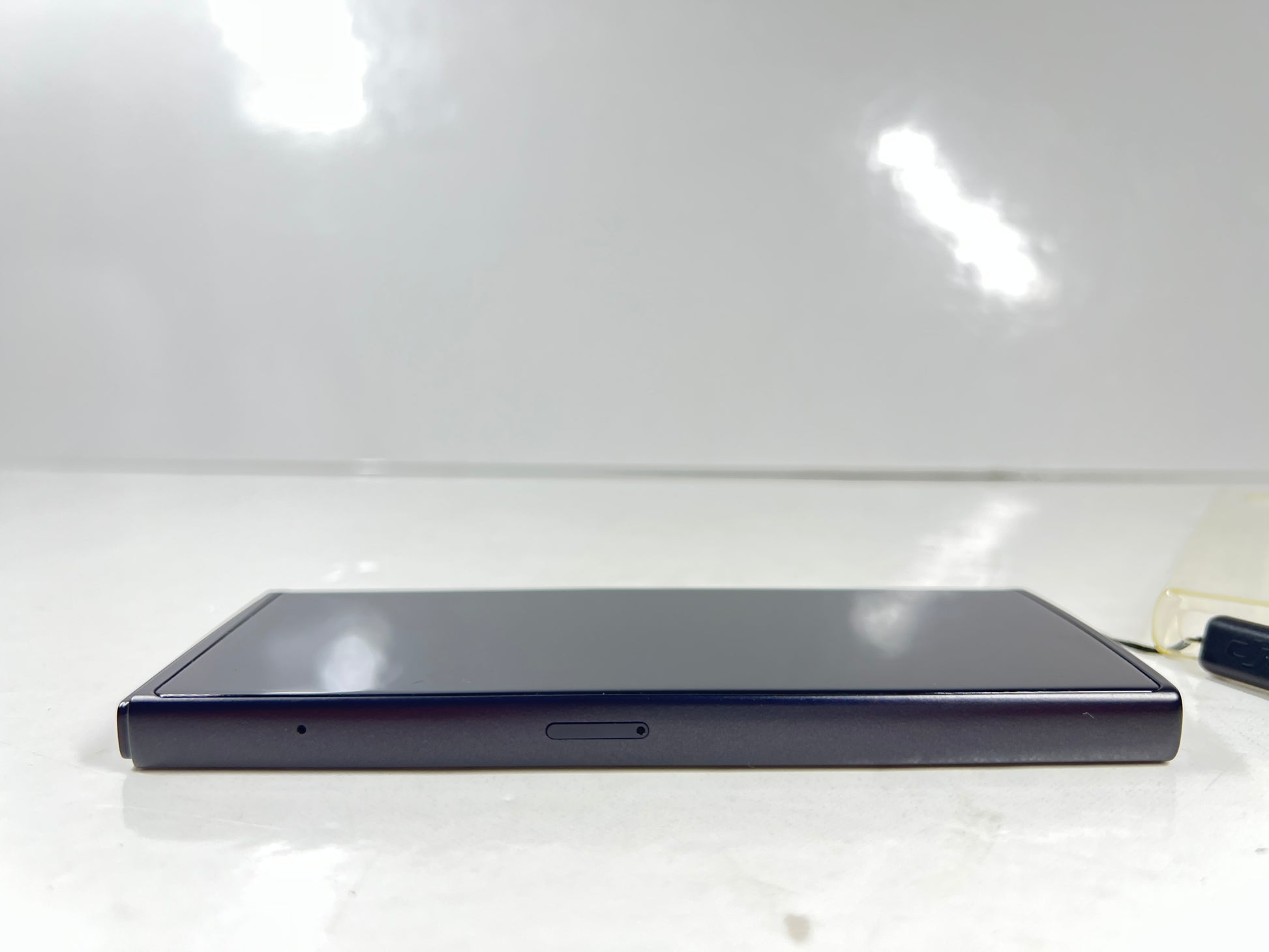 iFlytek Translator 4.0 AI device in navy with wrist strap, rear camera, and side buttons shown
