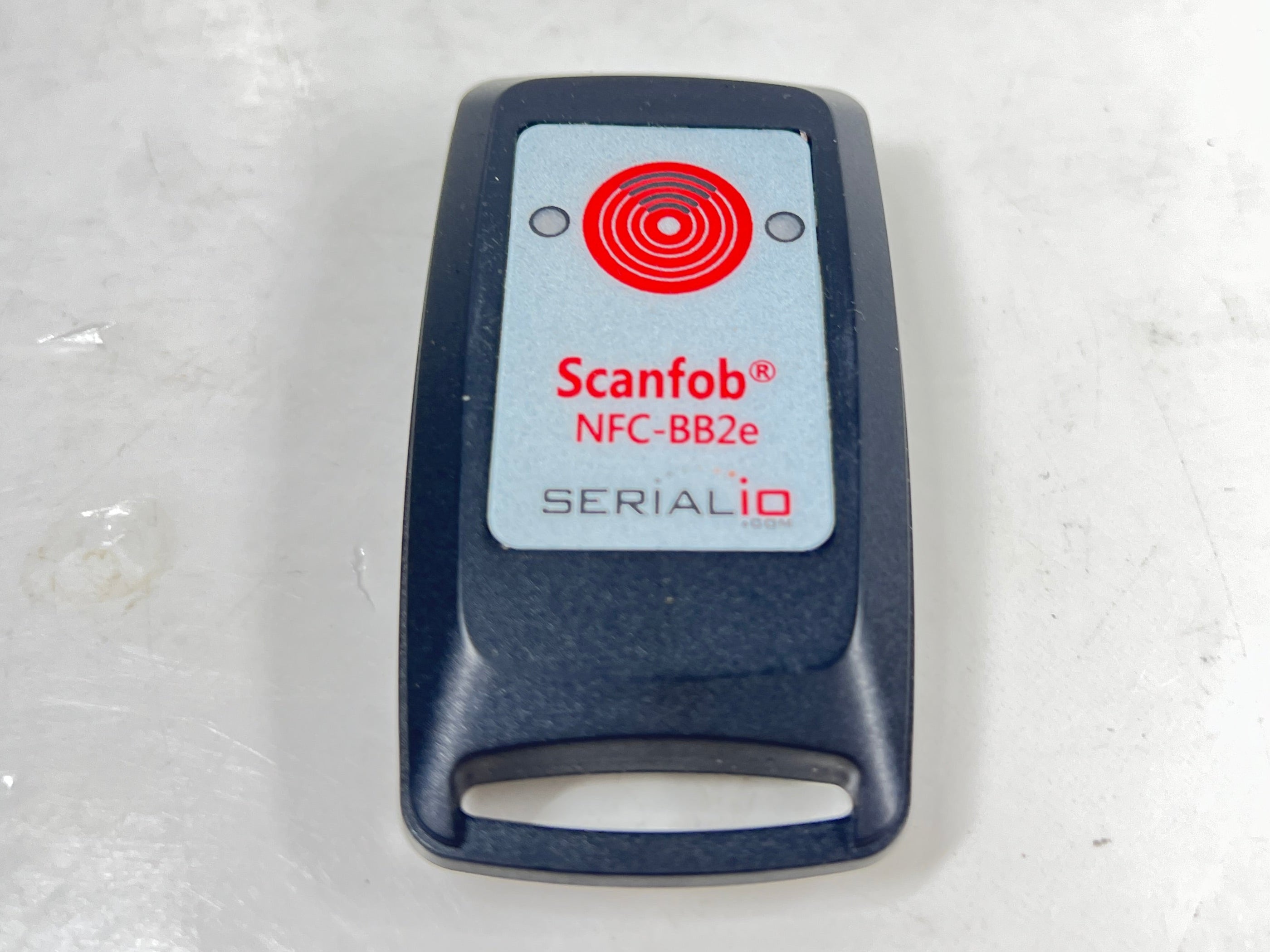 Compact Scanfob NFC-BB2e NFC scanner by Serialio with red target logo and label details