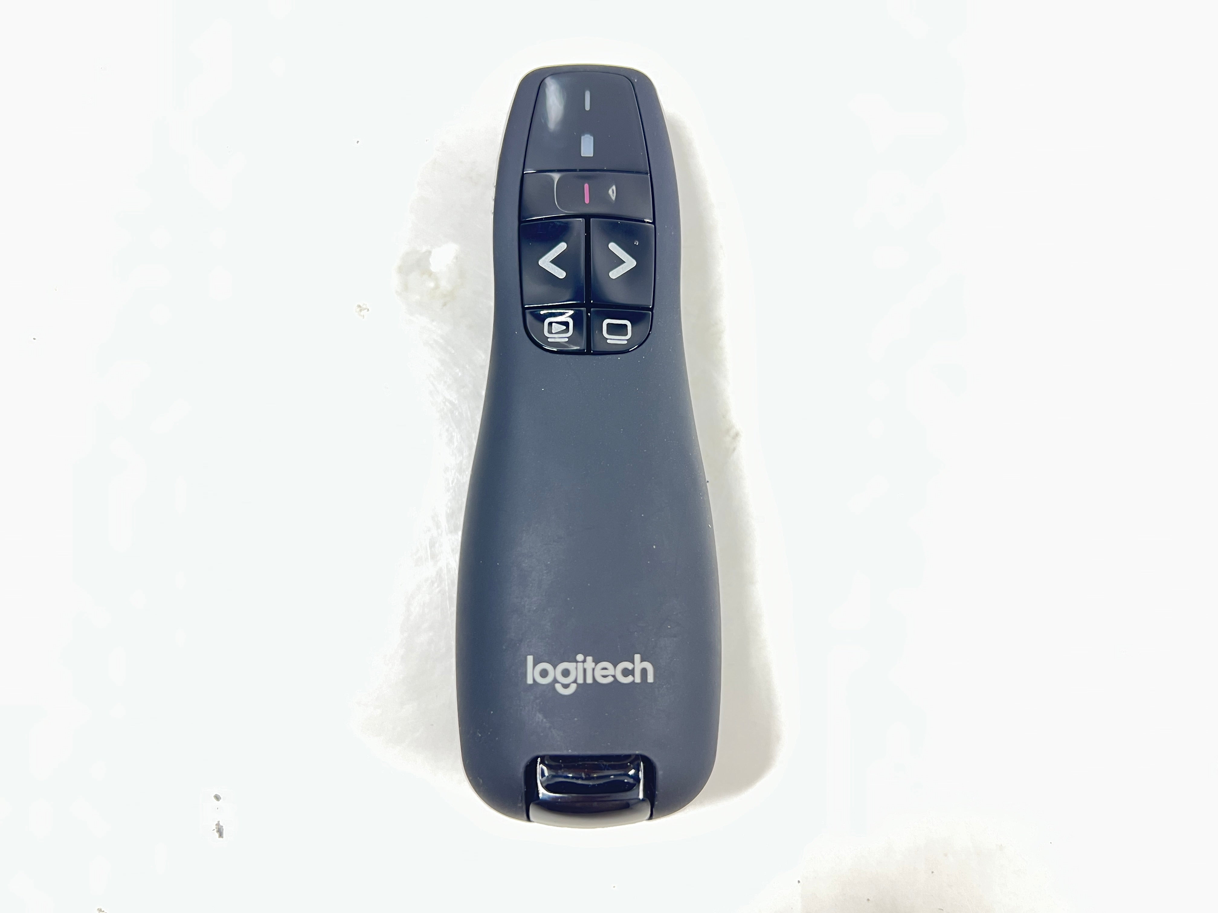 Black Logitech R400 wireless presentation remote with laser pointer and slideshow controls shown from multiple angles.