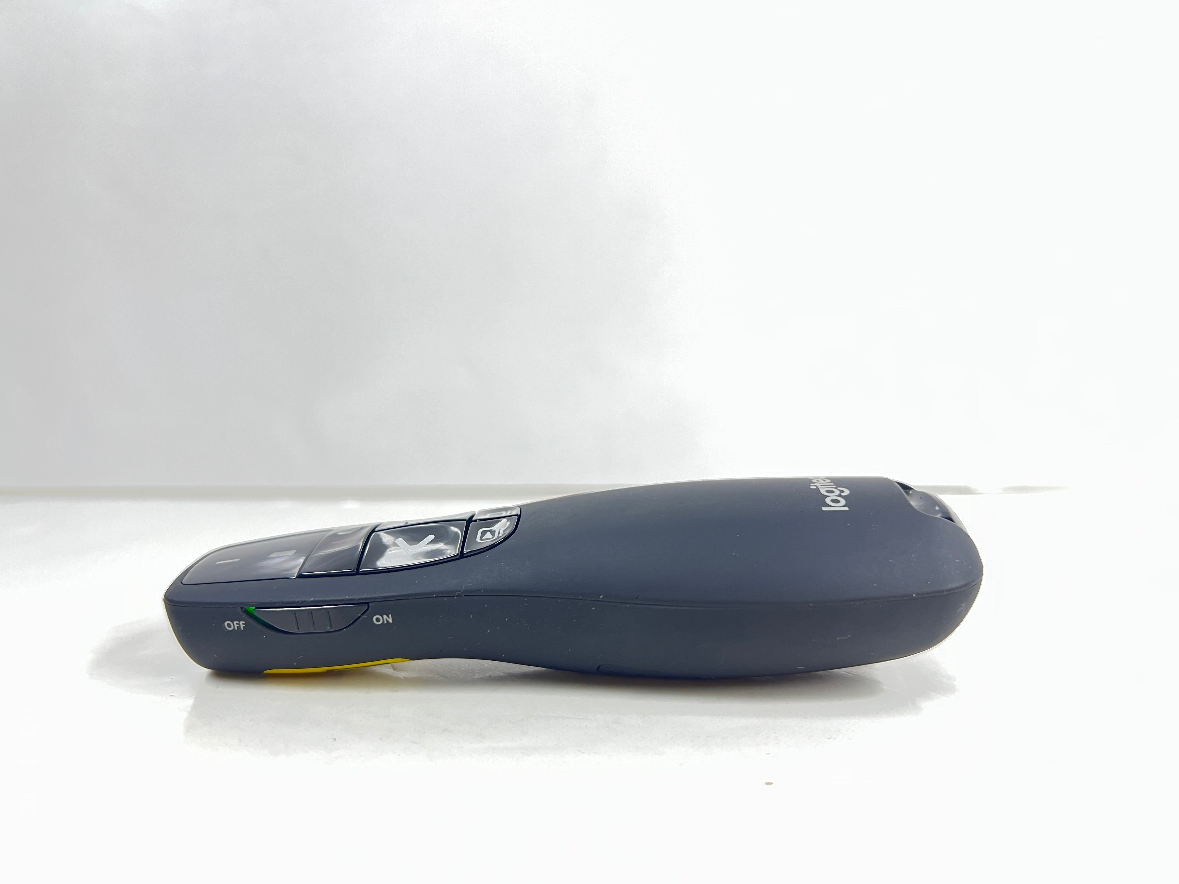 Black Logitech R400 wireless presentation remote with laser pointer and slideshow controls shown from multiple angles.