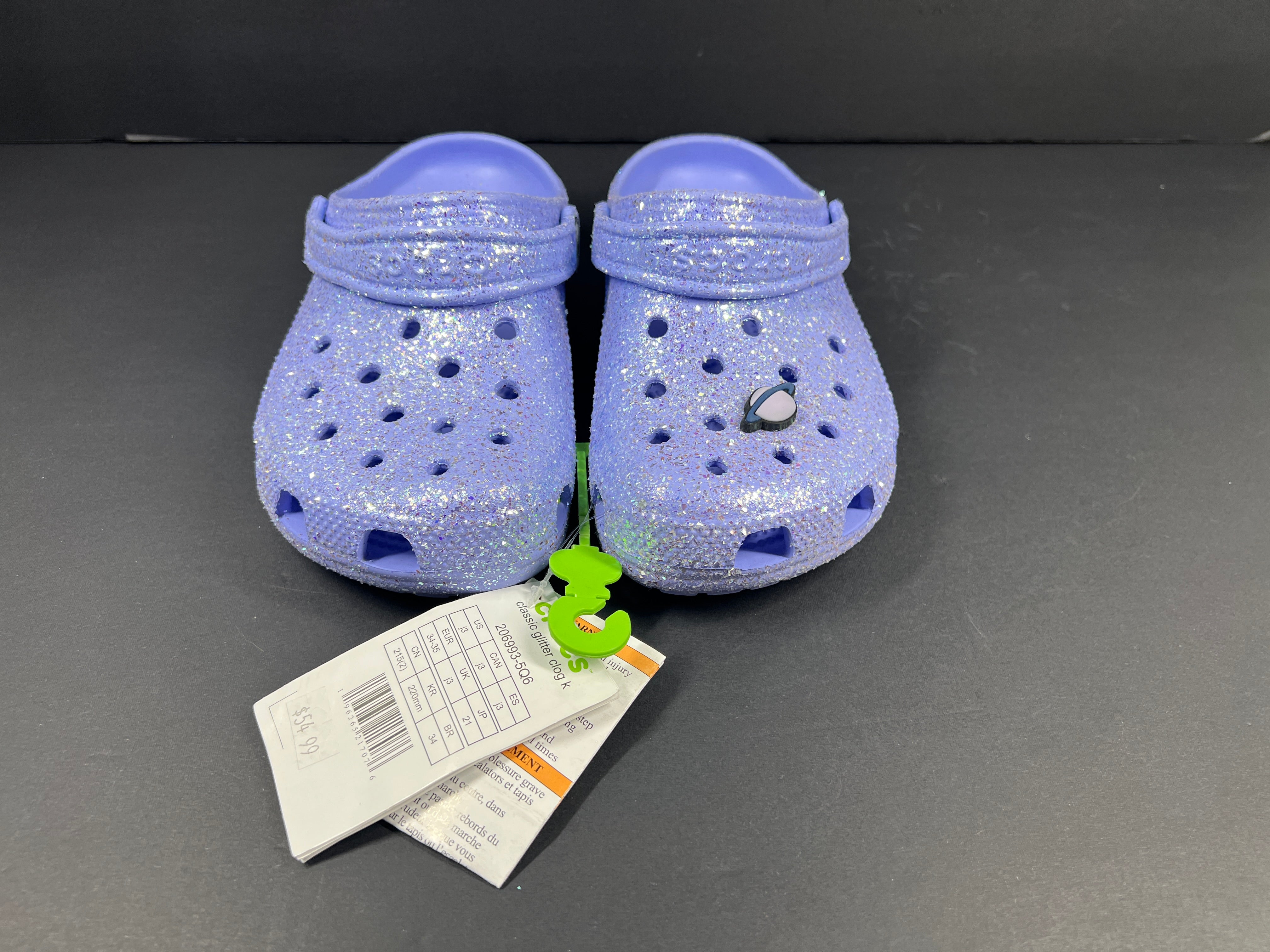 A pair of purple Crocs Classic Glitter Clogs