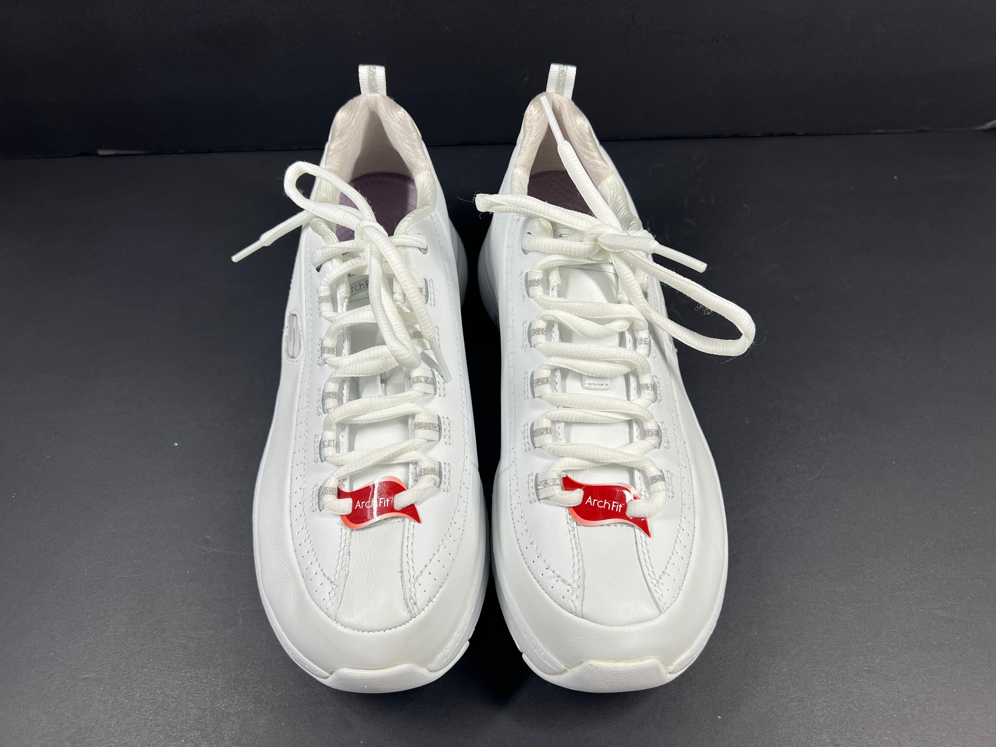 A pair of white Skechers Arch Fit women's sneakers