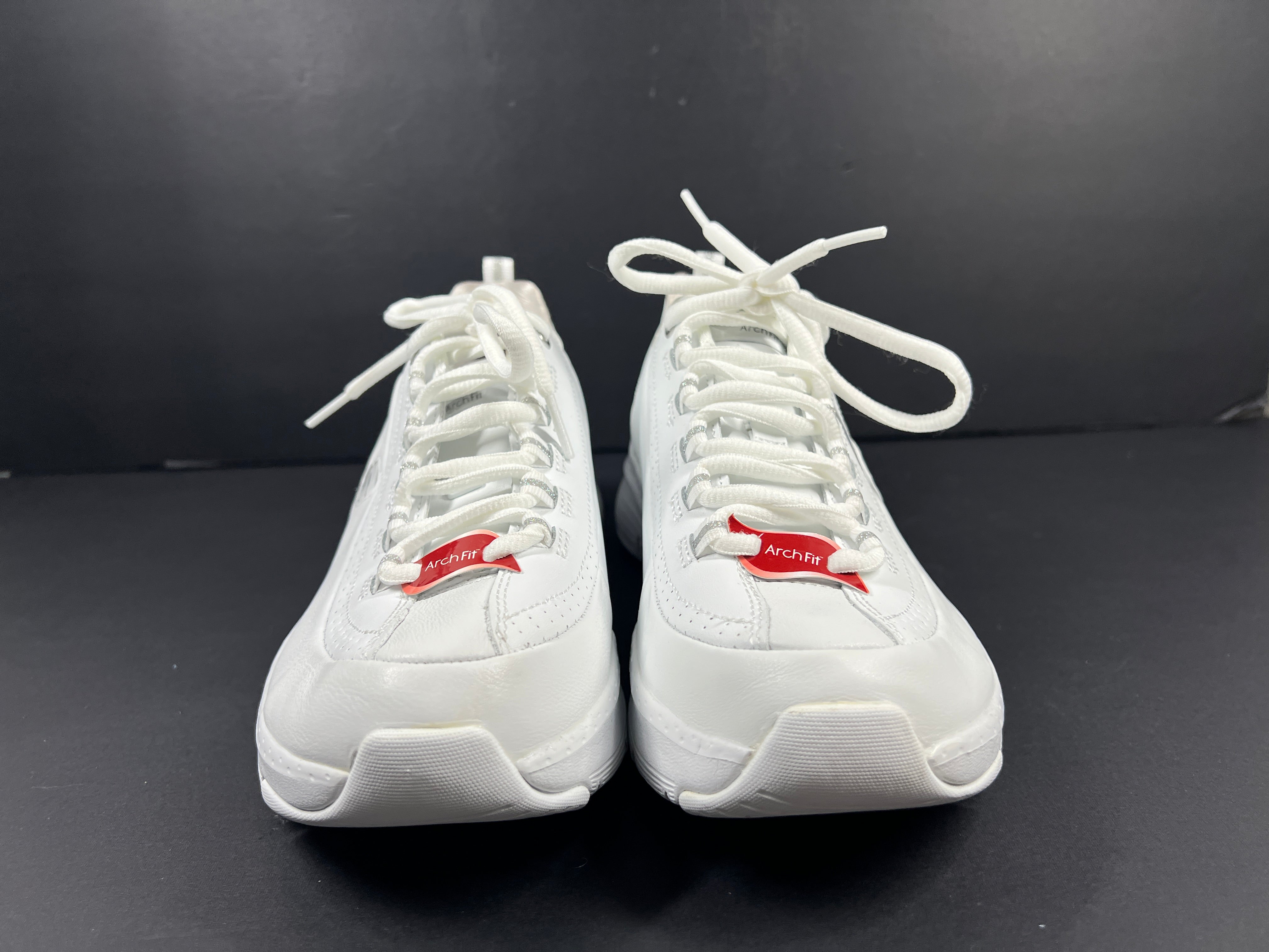 A pair of white Skechers Arch Fit women's sneakers