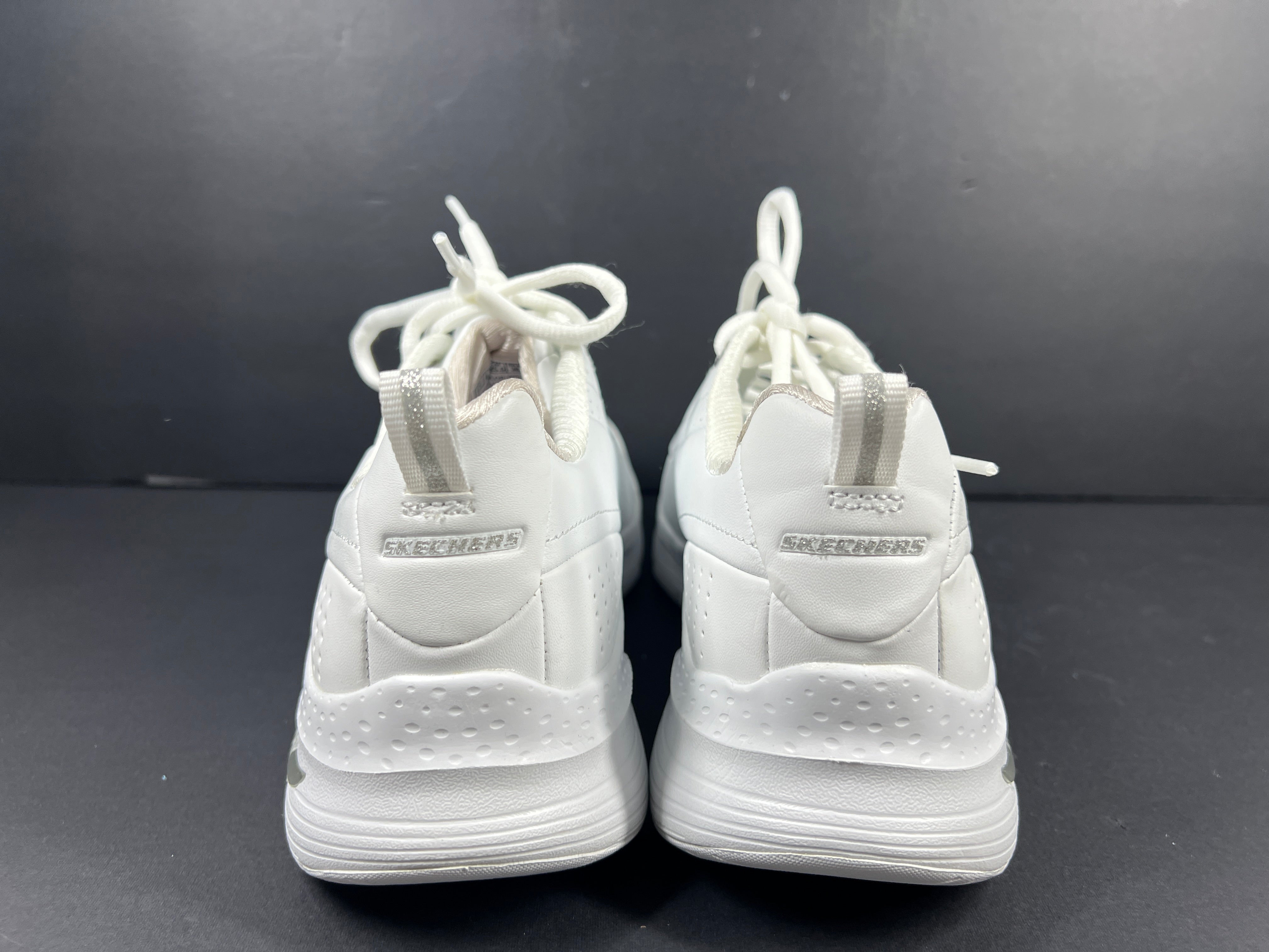 A pair of white Skechers Arch Fit women's sneakers