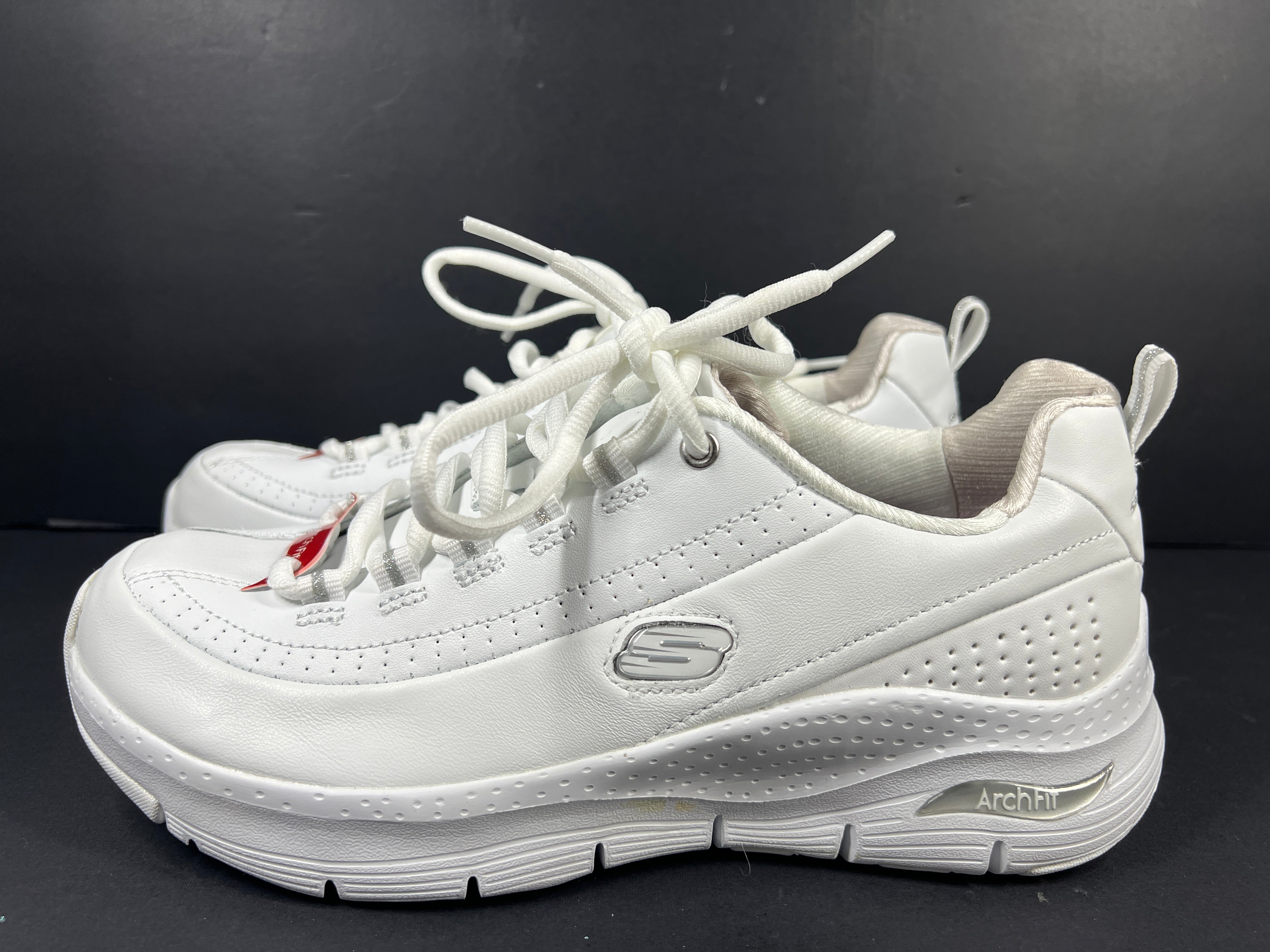 A pair of white Skechers Arch Fit women's sneakers