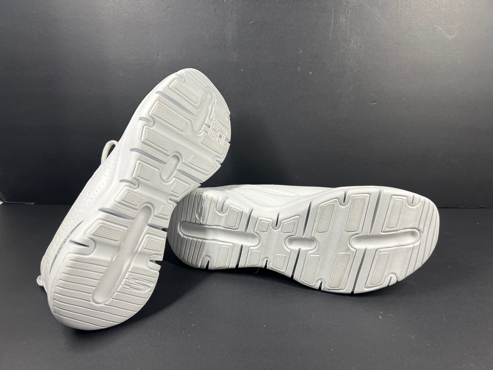 A pair of white Skechers Arch Fit women's sneakers