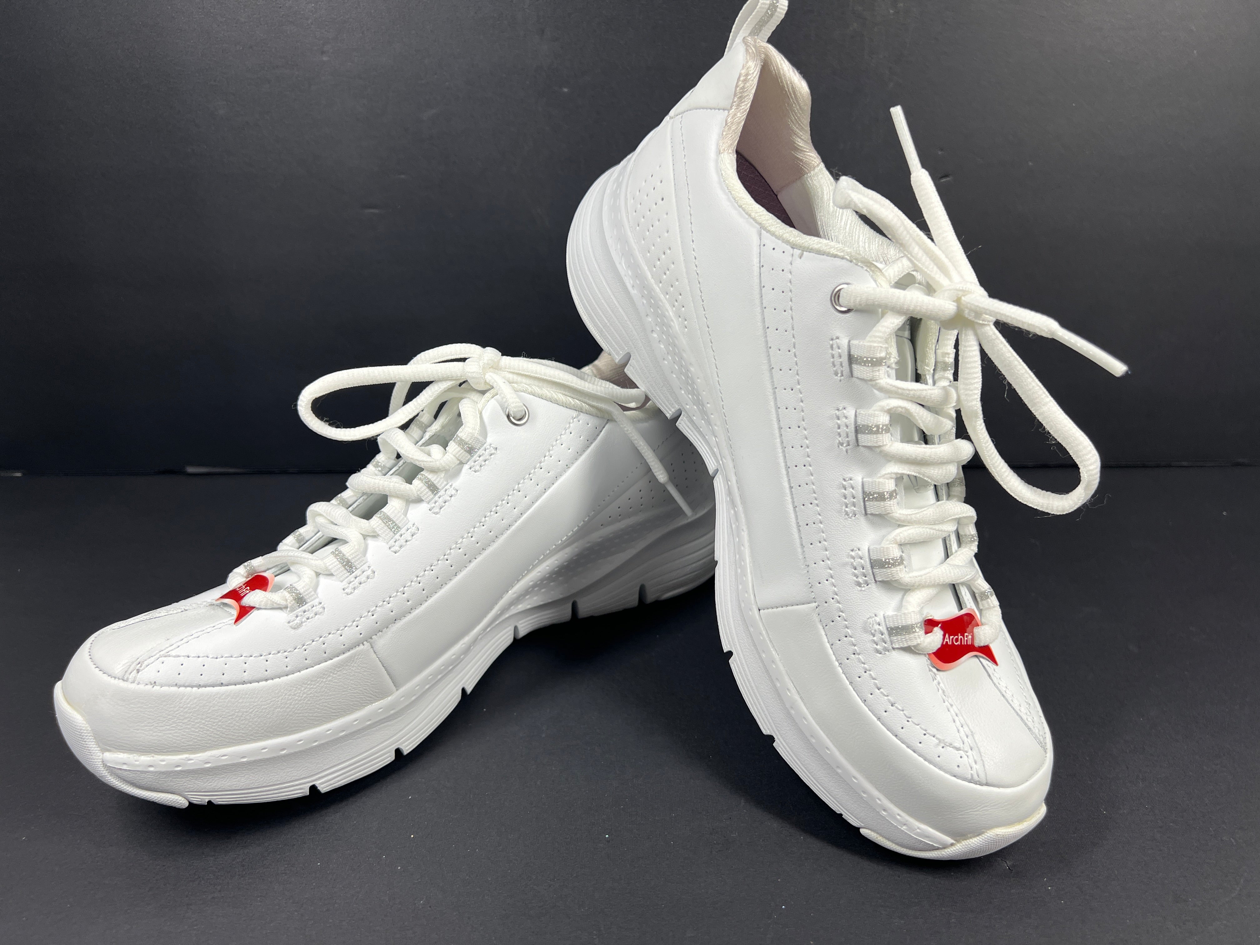 A pair of white Skechers Arch Fit women's sneakers