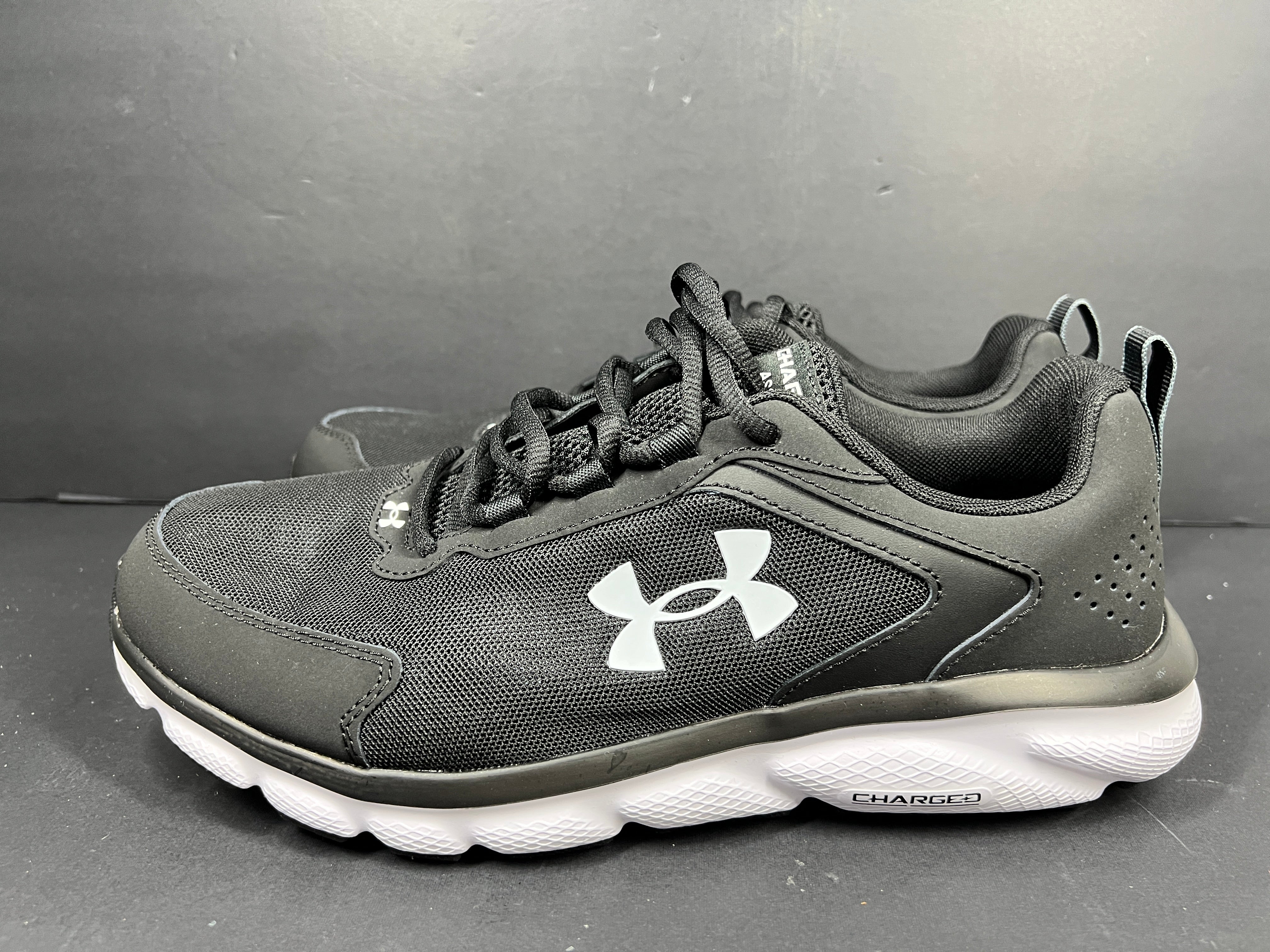 A pair of black Under Armour Charged Assert 9 running shoes for men