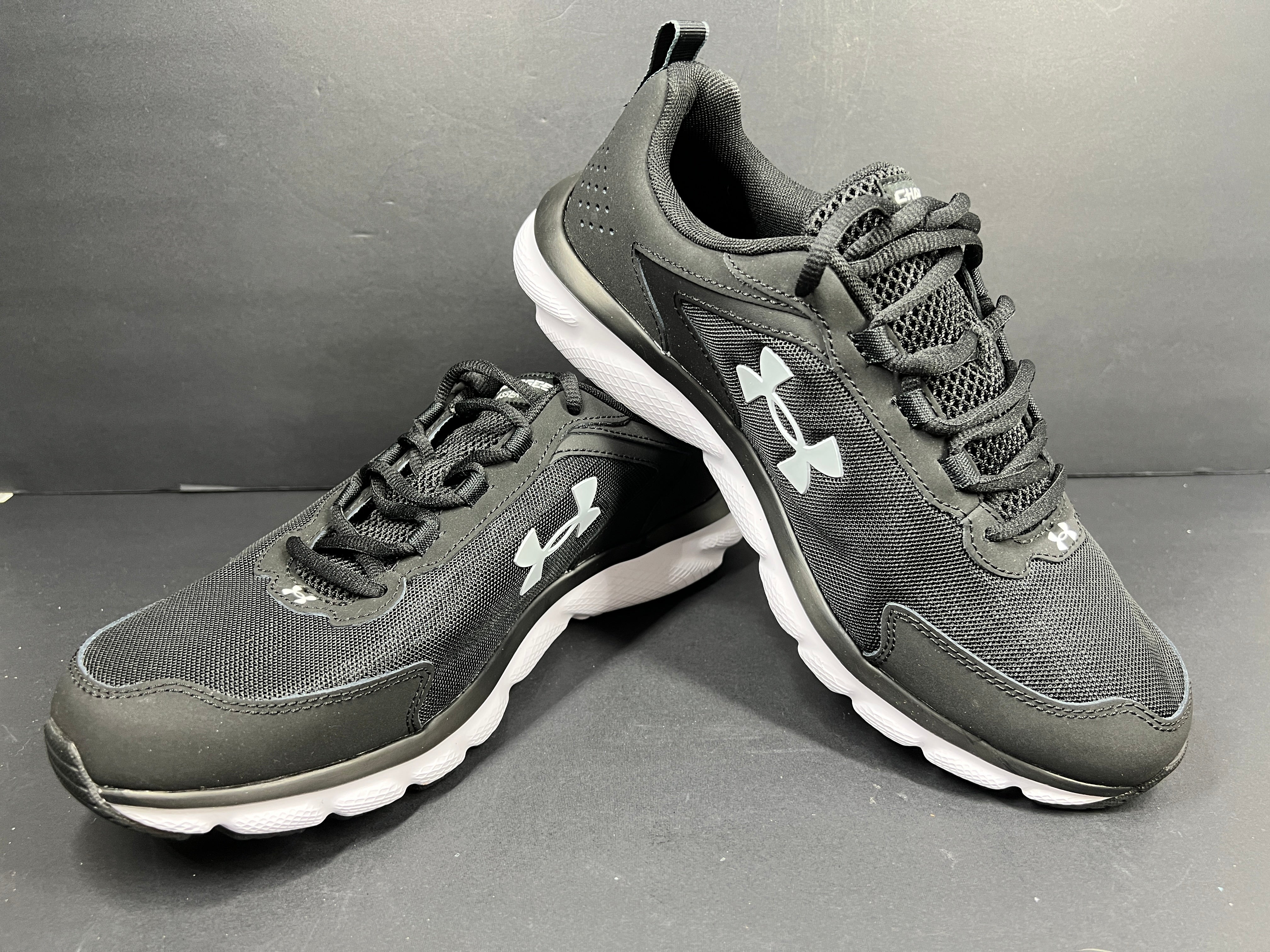 A pair of black Under Armour Charged Assert 9 running shoes for men