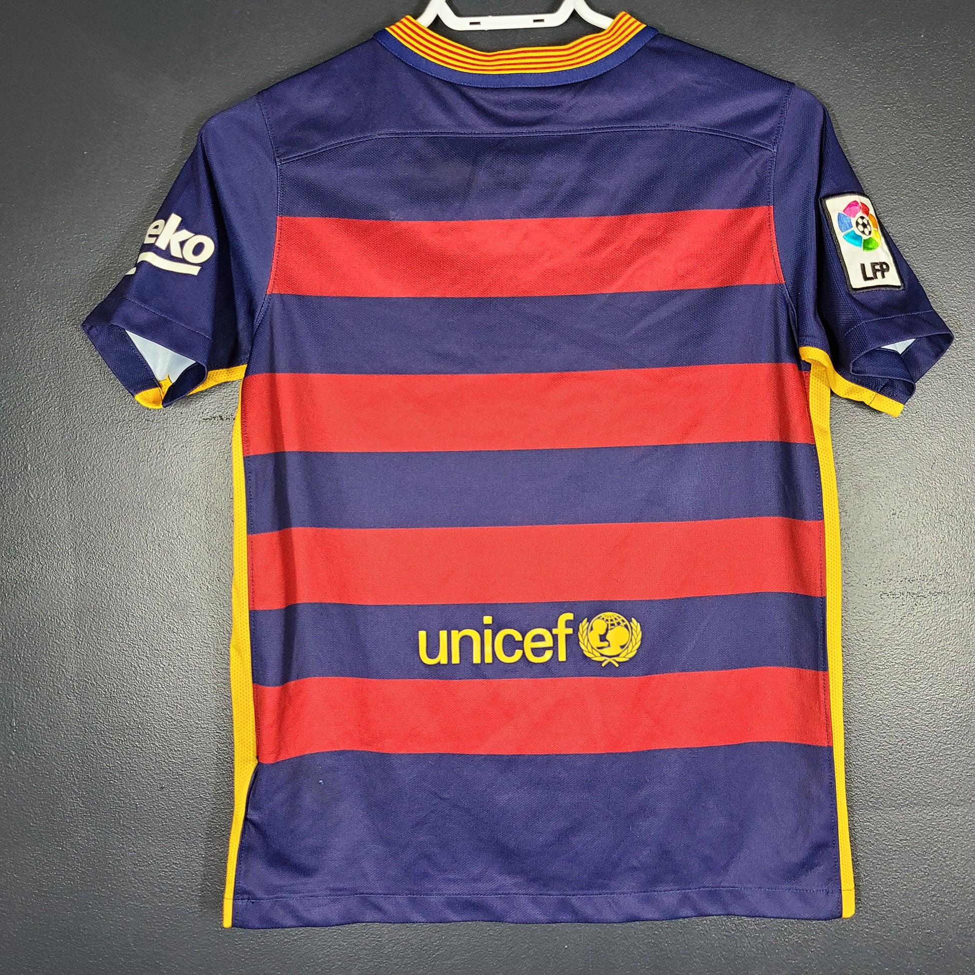 FC Barcelona 2015 youth home jersey in red and navy with Qatar Airways and UNICEF logos visible.