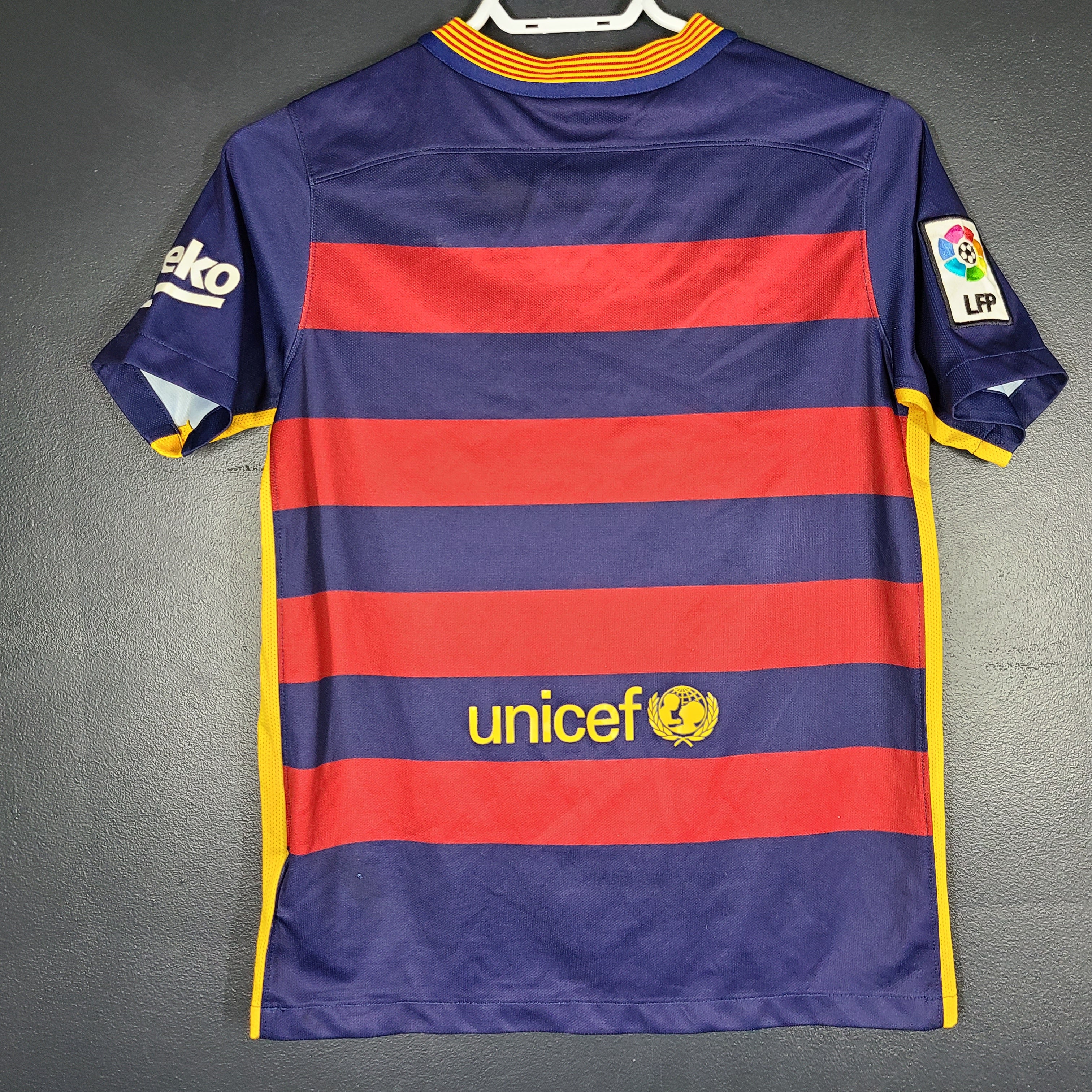 FC Barcelona 2015 youth home jersey in red and navy with Qatar Airways and UNICEF logos visible.