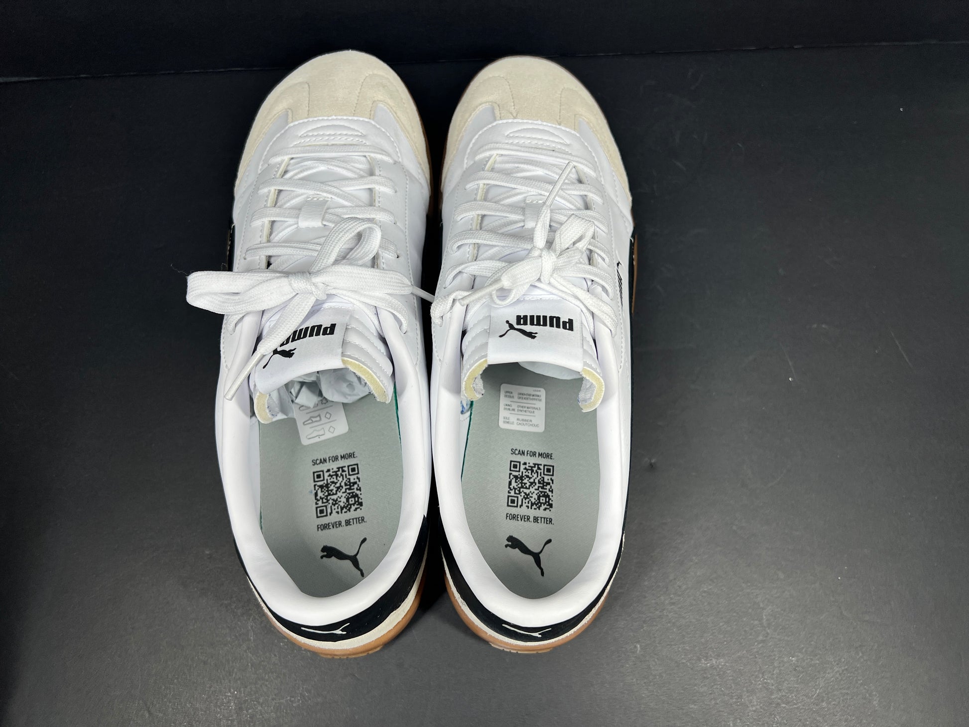 A pair of stylish white and black Puma Men's Sneakers in suede material